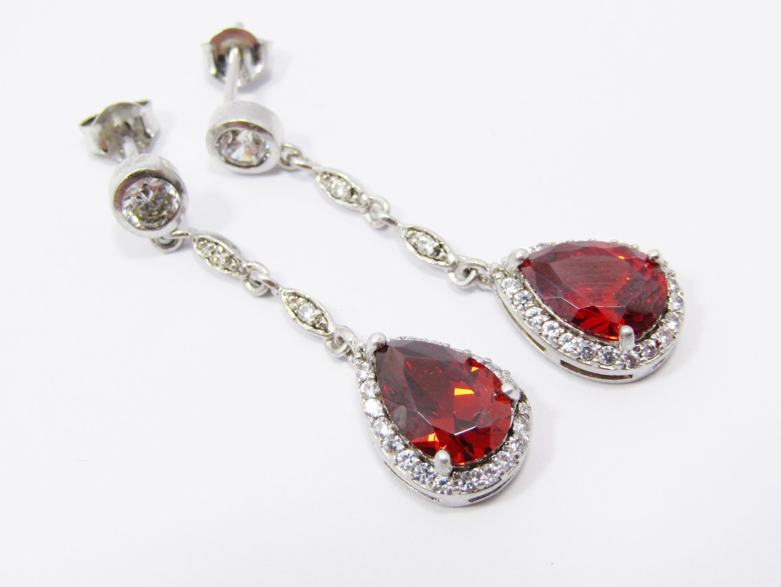 A Gorgeous Pair of Red Stone Zirconia Dangling Earrings in Sterling Silver.