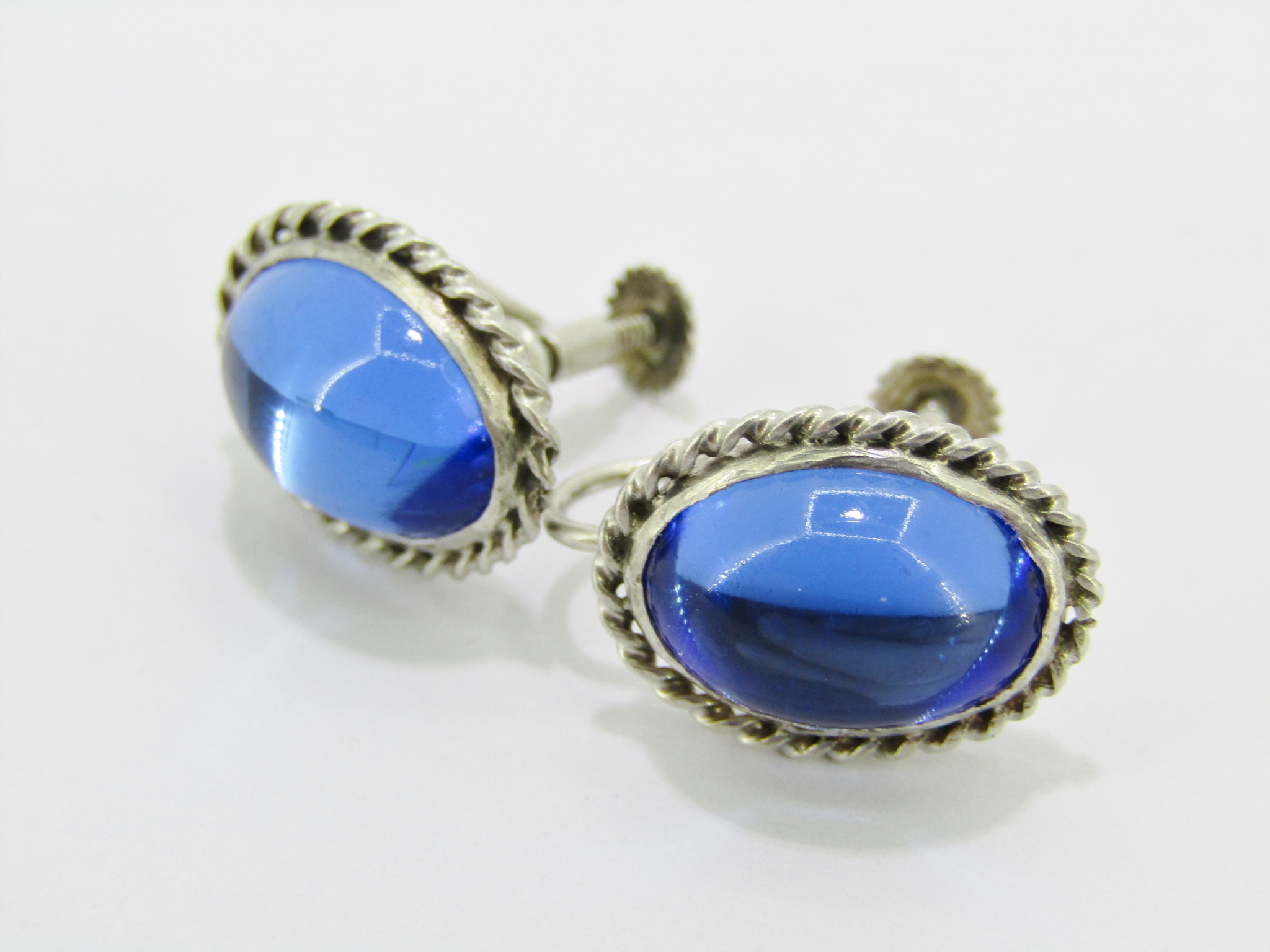 A Gorgeous Vintage Pair of Blue Paste Stone Screw Back Earrings in Sterling Silver.