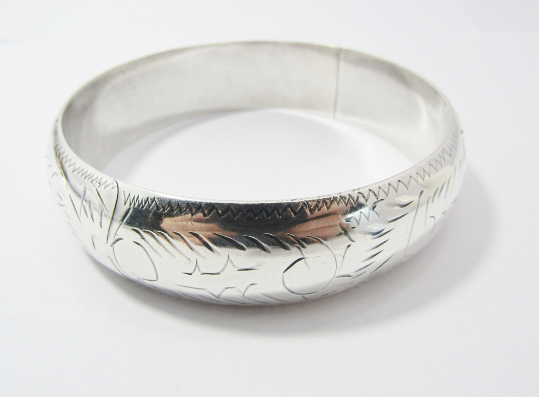 A Gorgeous Broad Engraved Hinged Bangle in Sterling Silver.