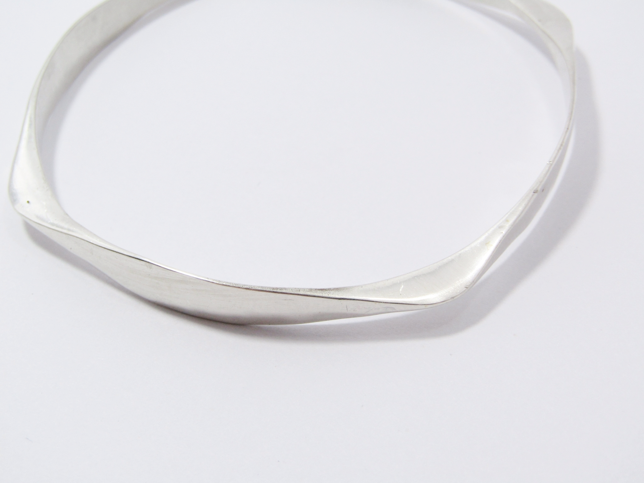 A Lovely Fancy Hammered Design Square Bangle in Sterling Silver.