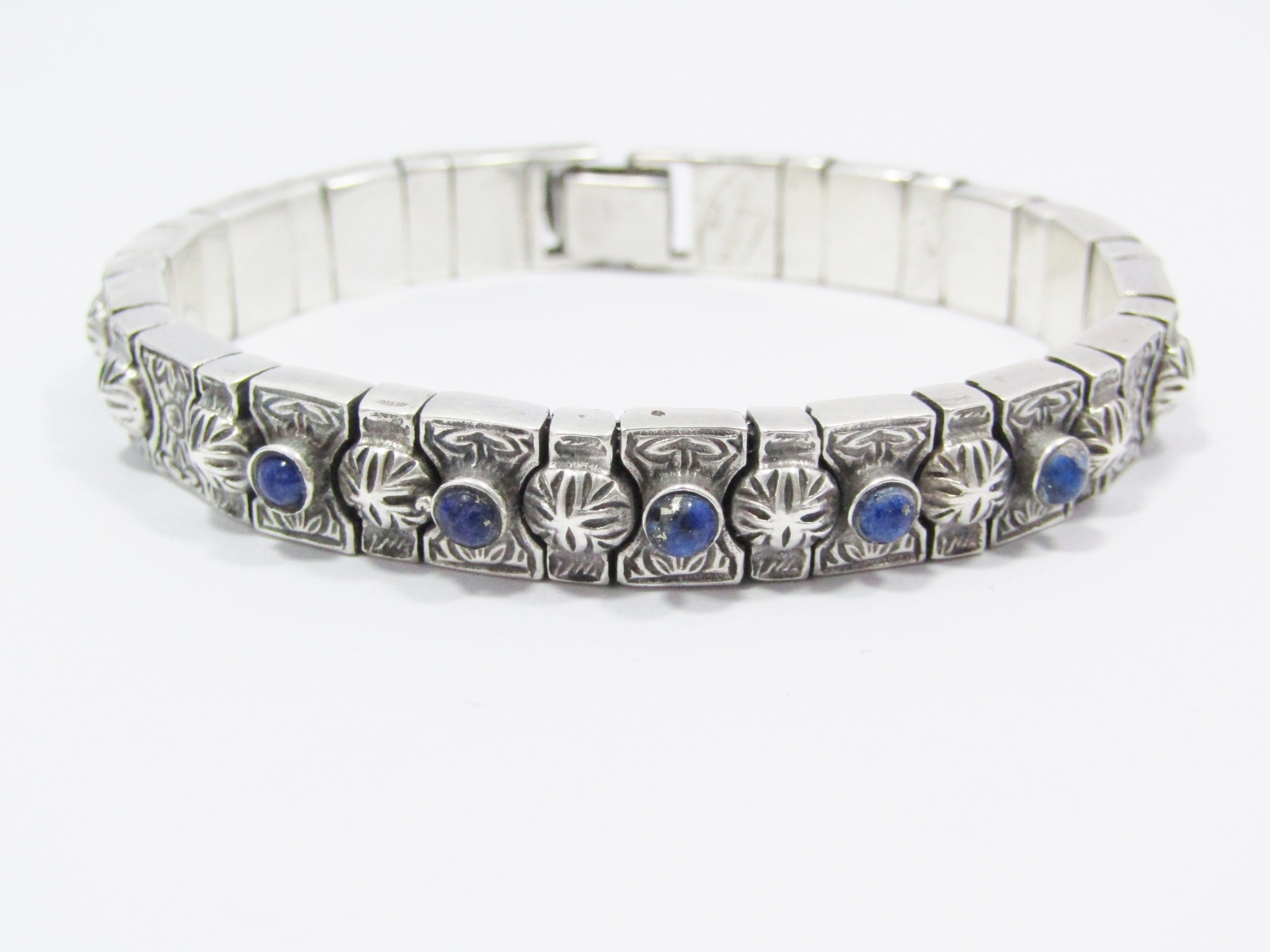 A Stunning Weighty Articulated Engraved Lapis Lazuli paneled Bracelet in Sterling Silver