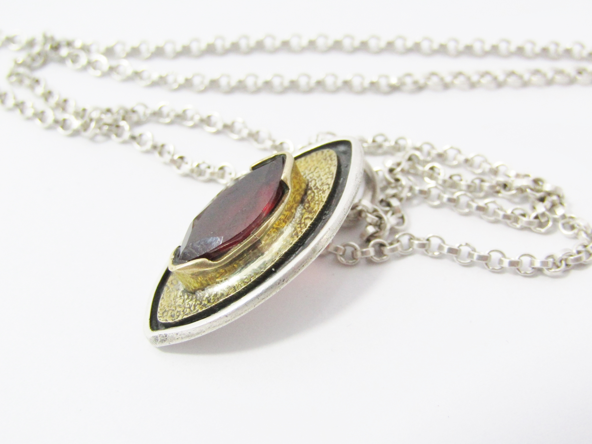 Stunning Two Tone Bronze And Silver Pendant With a Garnet On Chain in Sterling Silver.