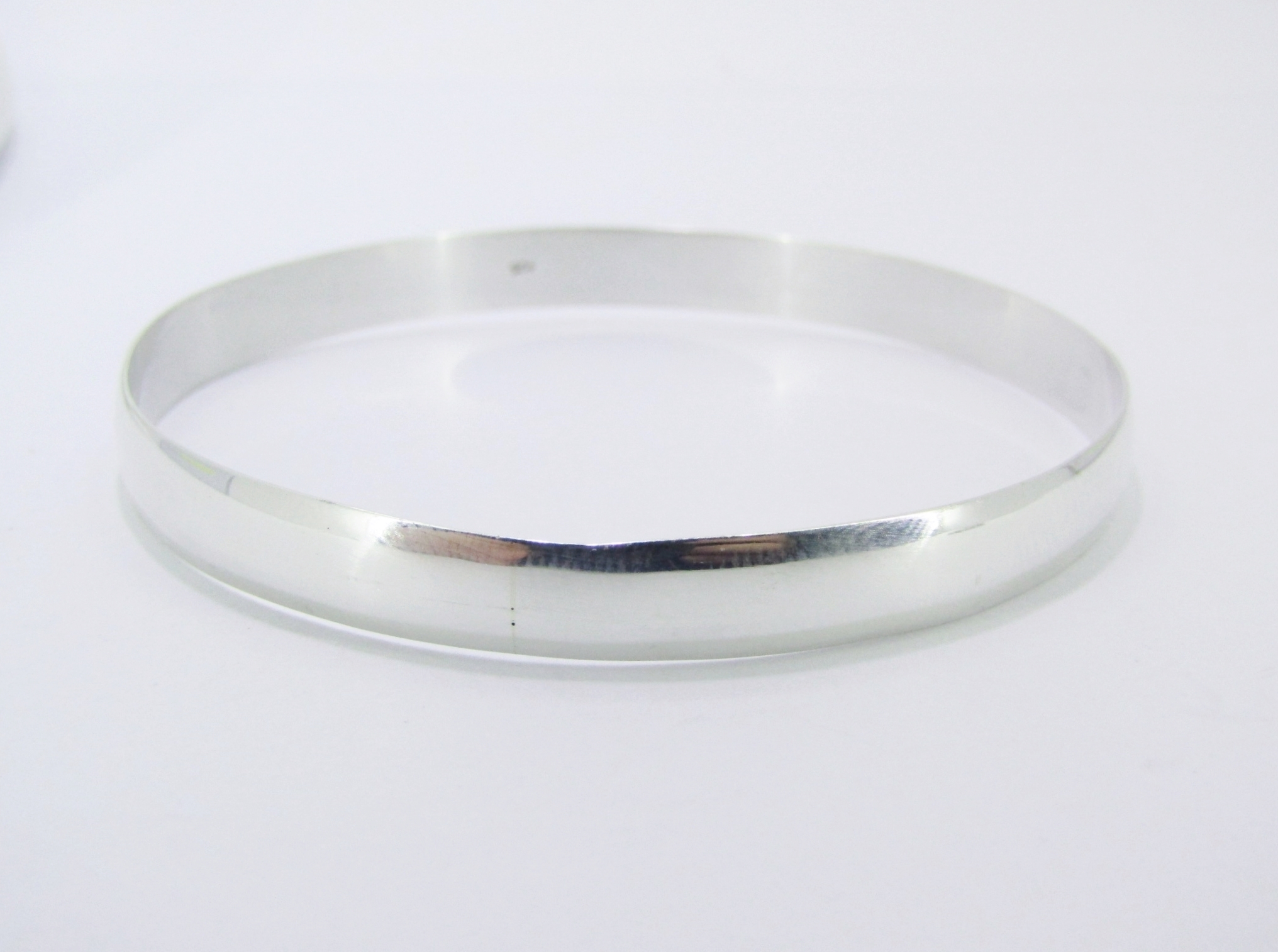 A Lovely Broad Solid Bangle in Sterling Silver.