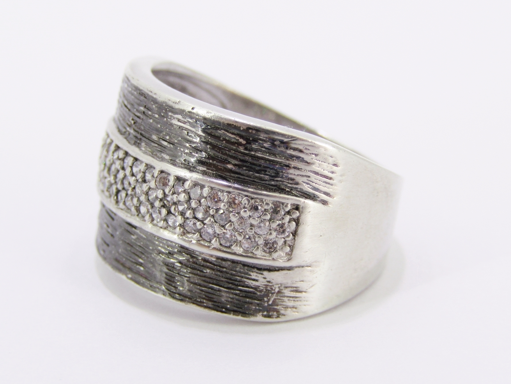 A Stunning Broad Textured Ring With Zirconia’s in Sterling Silver.
