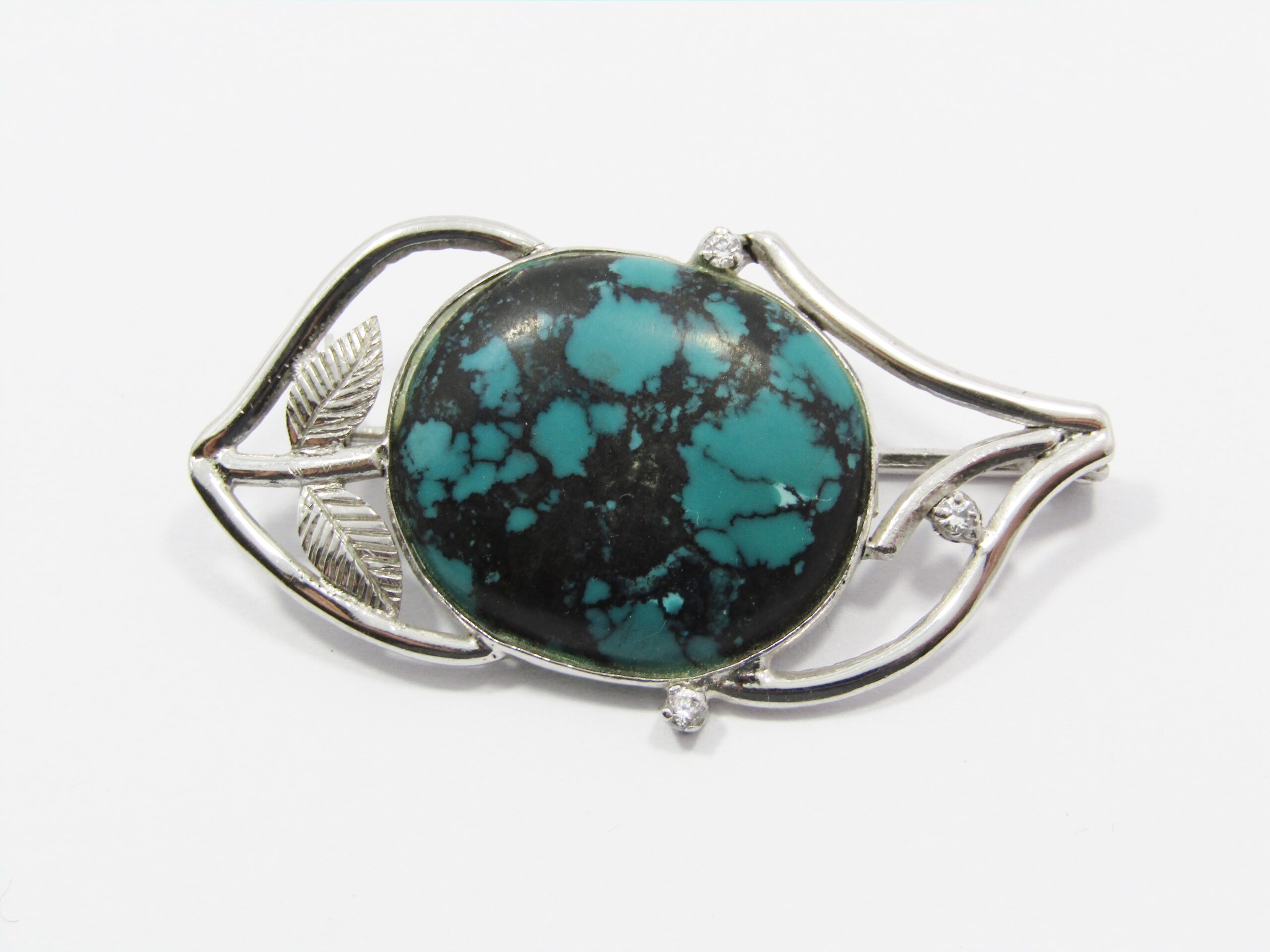 A Stunning Brooch With a Large Faux Turquois Stone in Sterling Silver.