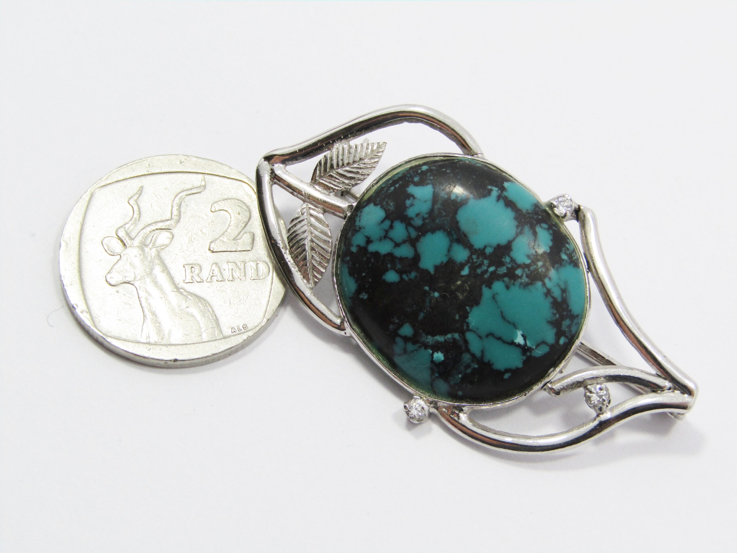 A Stunning Brooch With a Large Faux Turquois Stone in Sterling Silver.