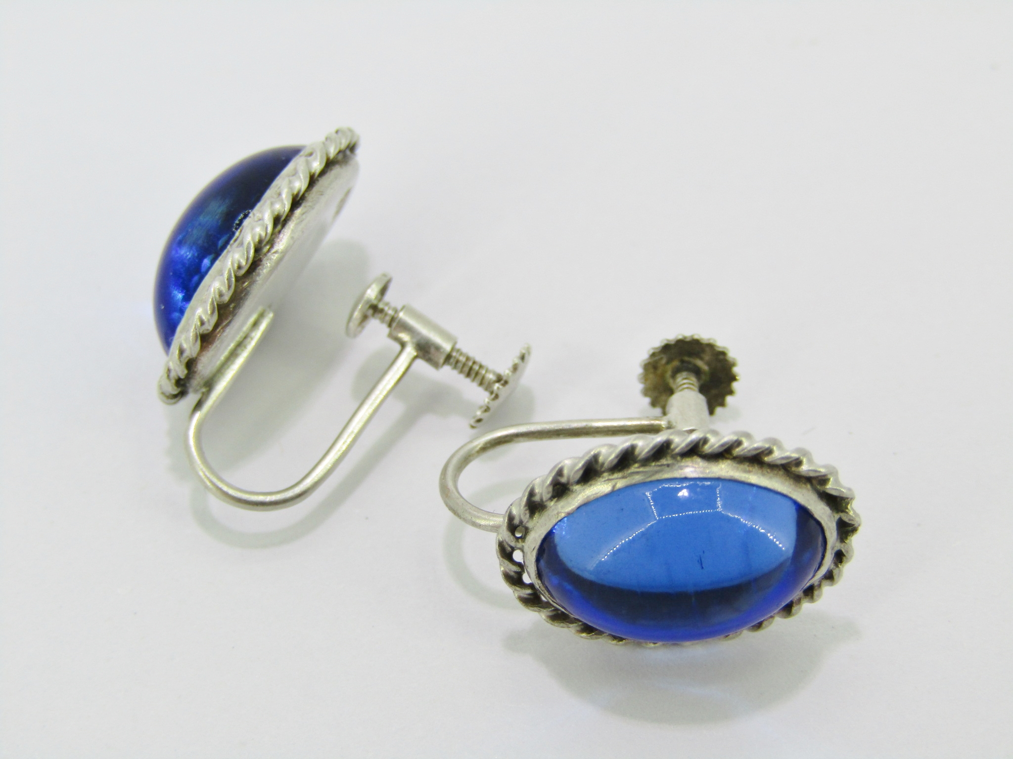 A Gorgeous Vintage Pair of Blue Paste Stone Screw Back Earrings in Sterling Silver.