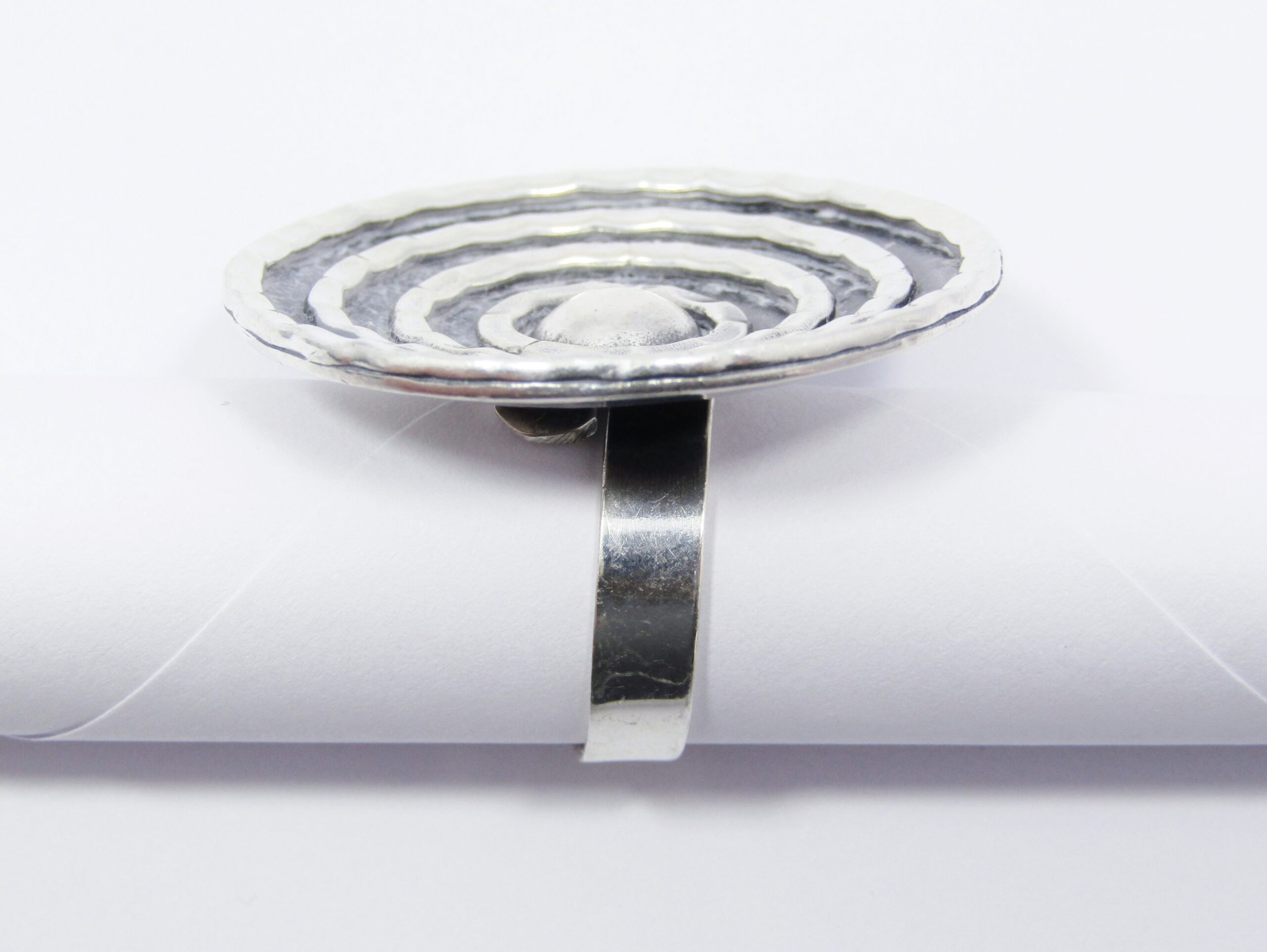 A Stunning Large Round Textured Ring with a Open-ended Band In Sterling Silver.