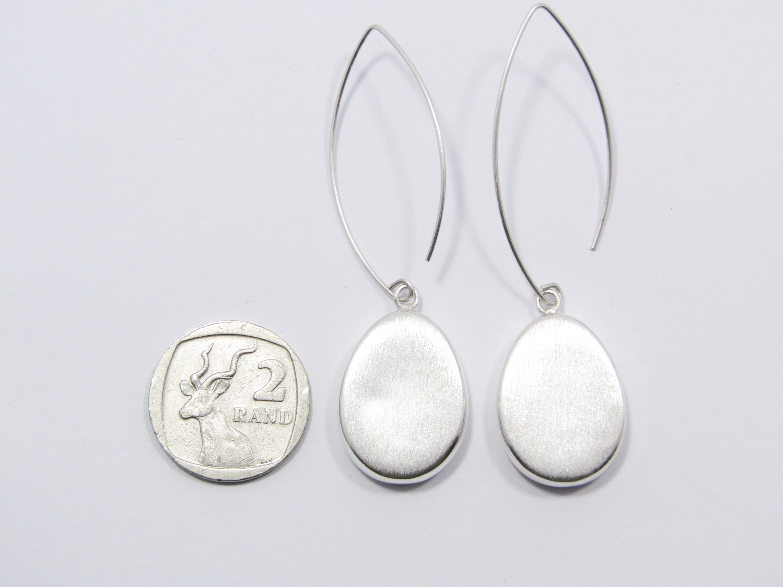 A Lovely Textured Design Dangling Earring in Sterling Silver.