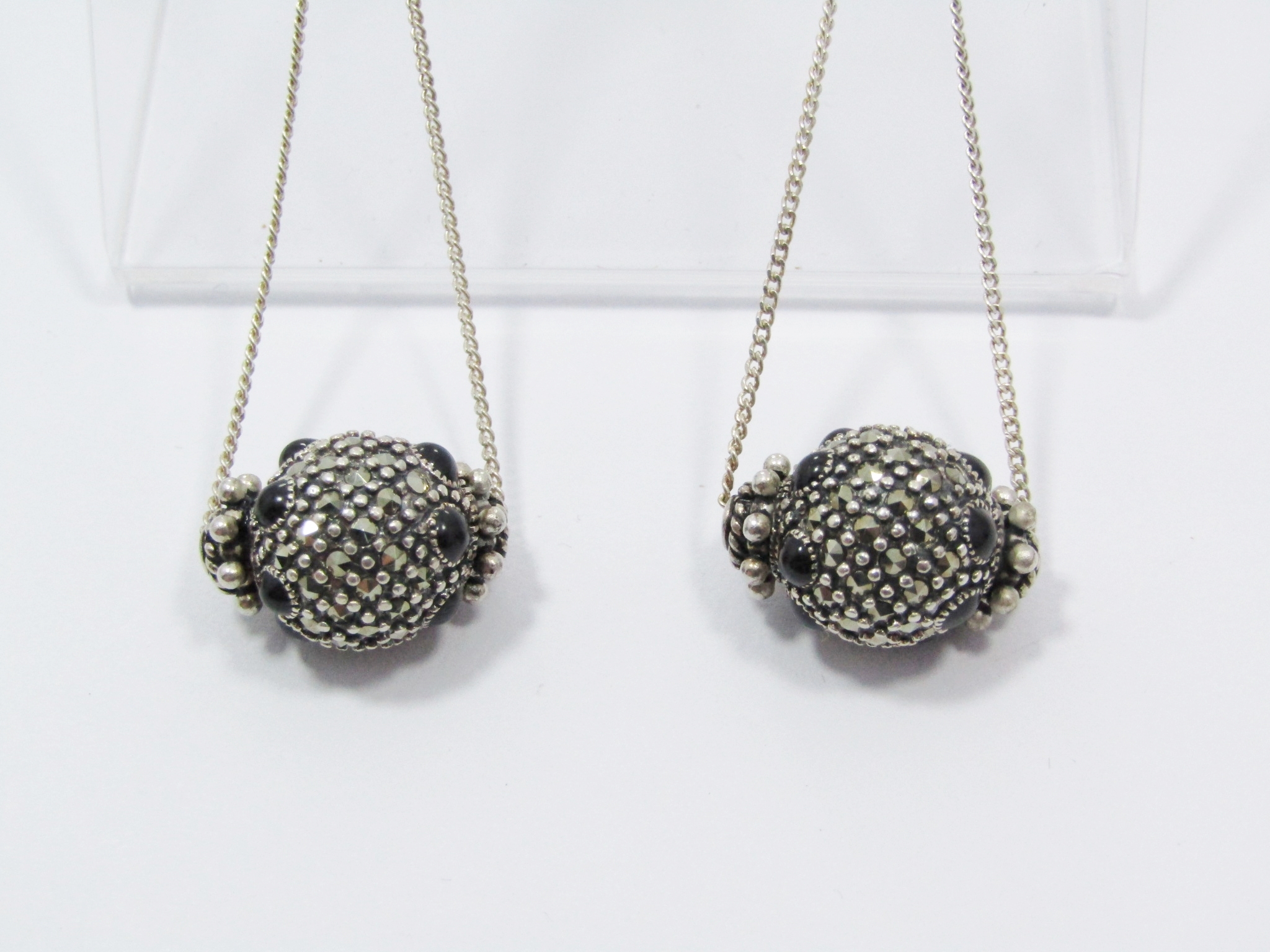 An Amazing Pair Of Dangling Ball Earrings Encrusted in Marcasite’s and Black Stones in Sterling Silver