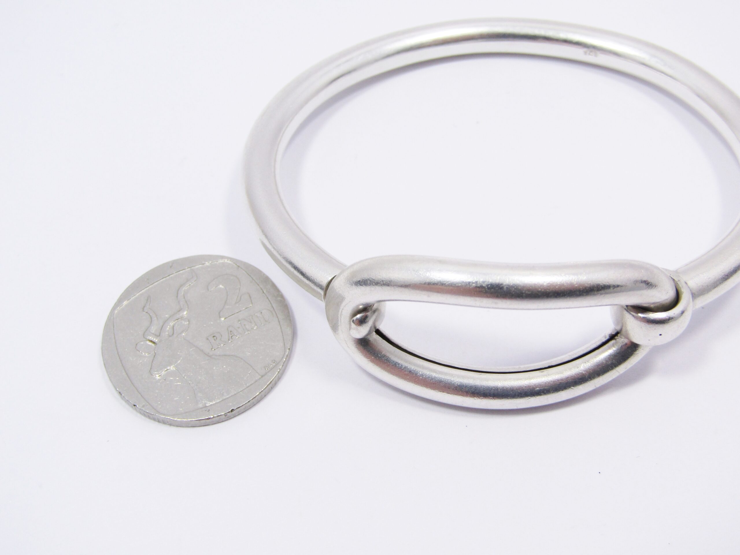 A Stunning Weighty Hinged Bangle in Sterling Silver.