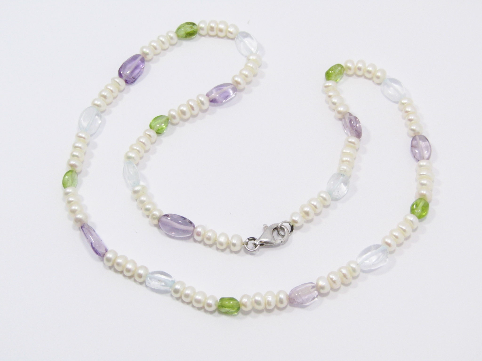 A String of Fresh Water Pearls and Gemstones With a Sterling Silver Clasp