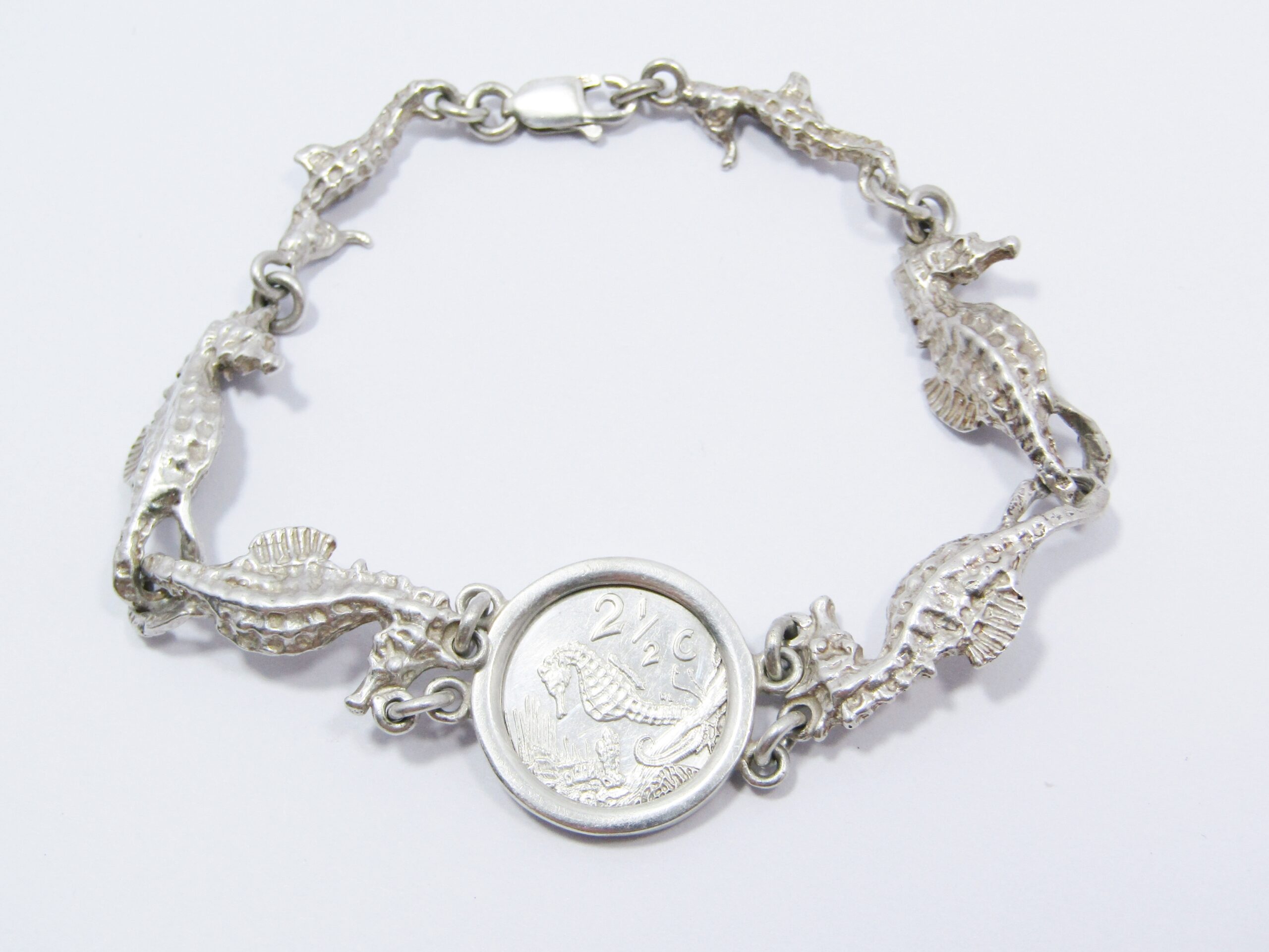 A Gorgeous Sea Horse Bracelet With a 1991 2 and a Half Cent Commemorative coin in Sterling Silver.