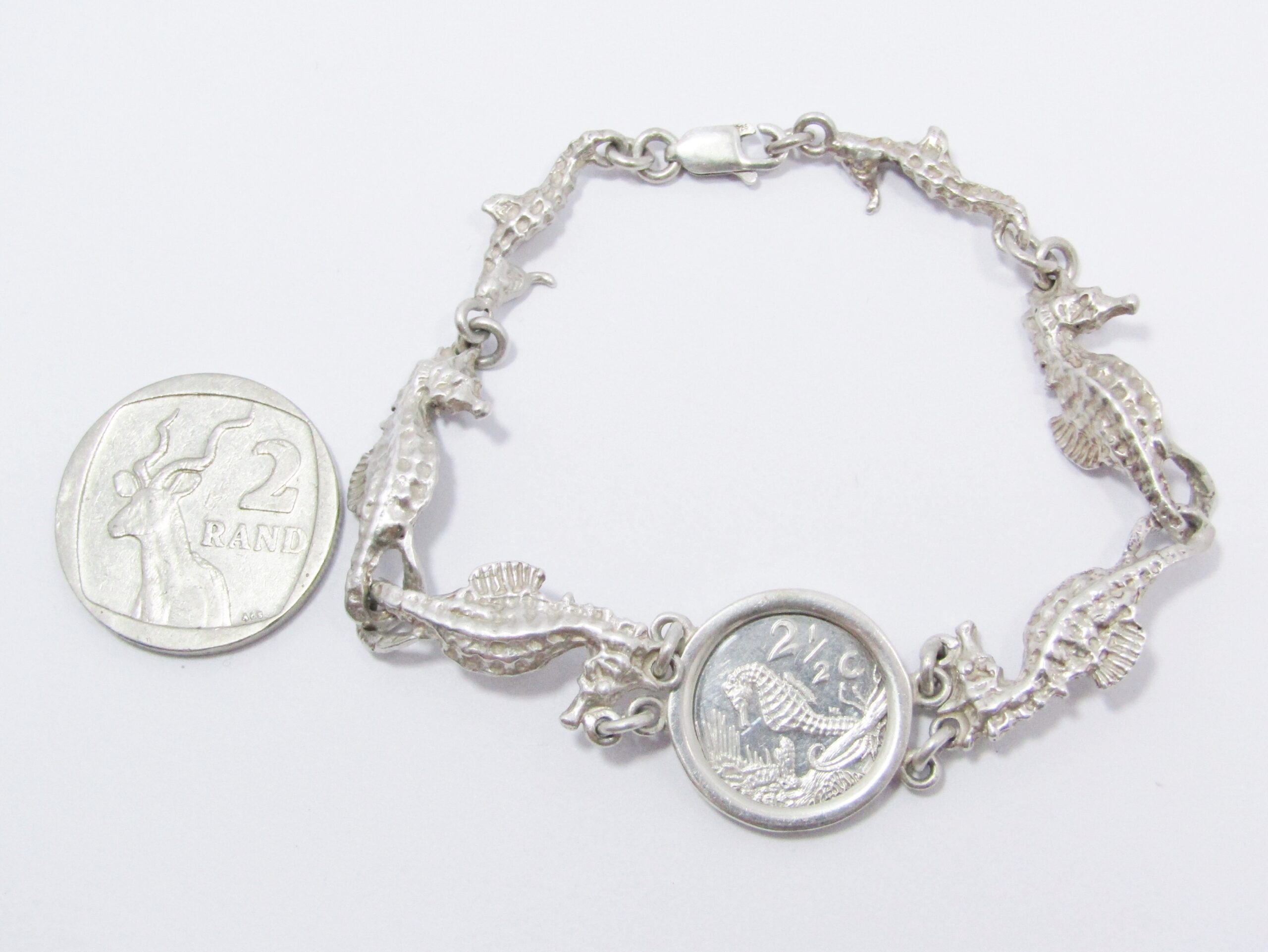 A Gorgeous Sea Horse Bracelet With a 1991 2 and a Half Cent Commemorative coin in Sterling Silver.