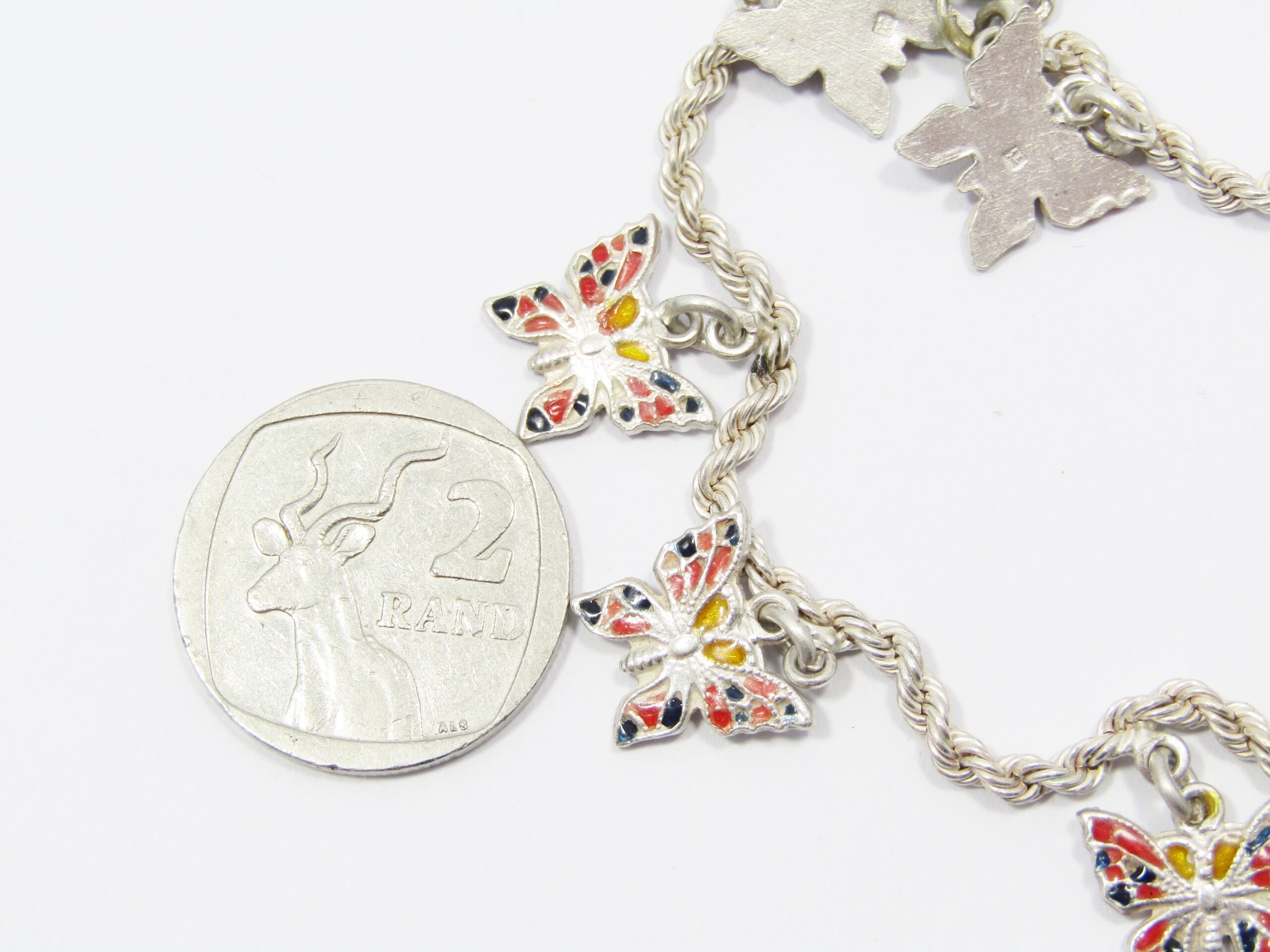 A Beautiful Enamel inlay Butterfly Charm Bracelet With Egyptian Hallmarks for 800 Silver