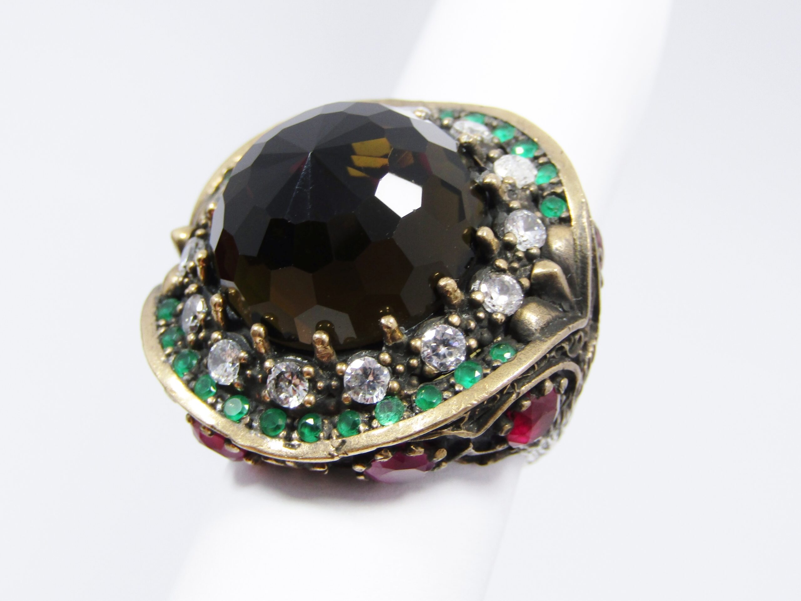 A Gorgeous Huge Facetted Smokey Color Crystal Surrounded With Pink Green and Clear Crystals