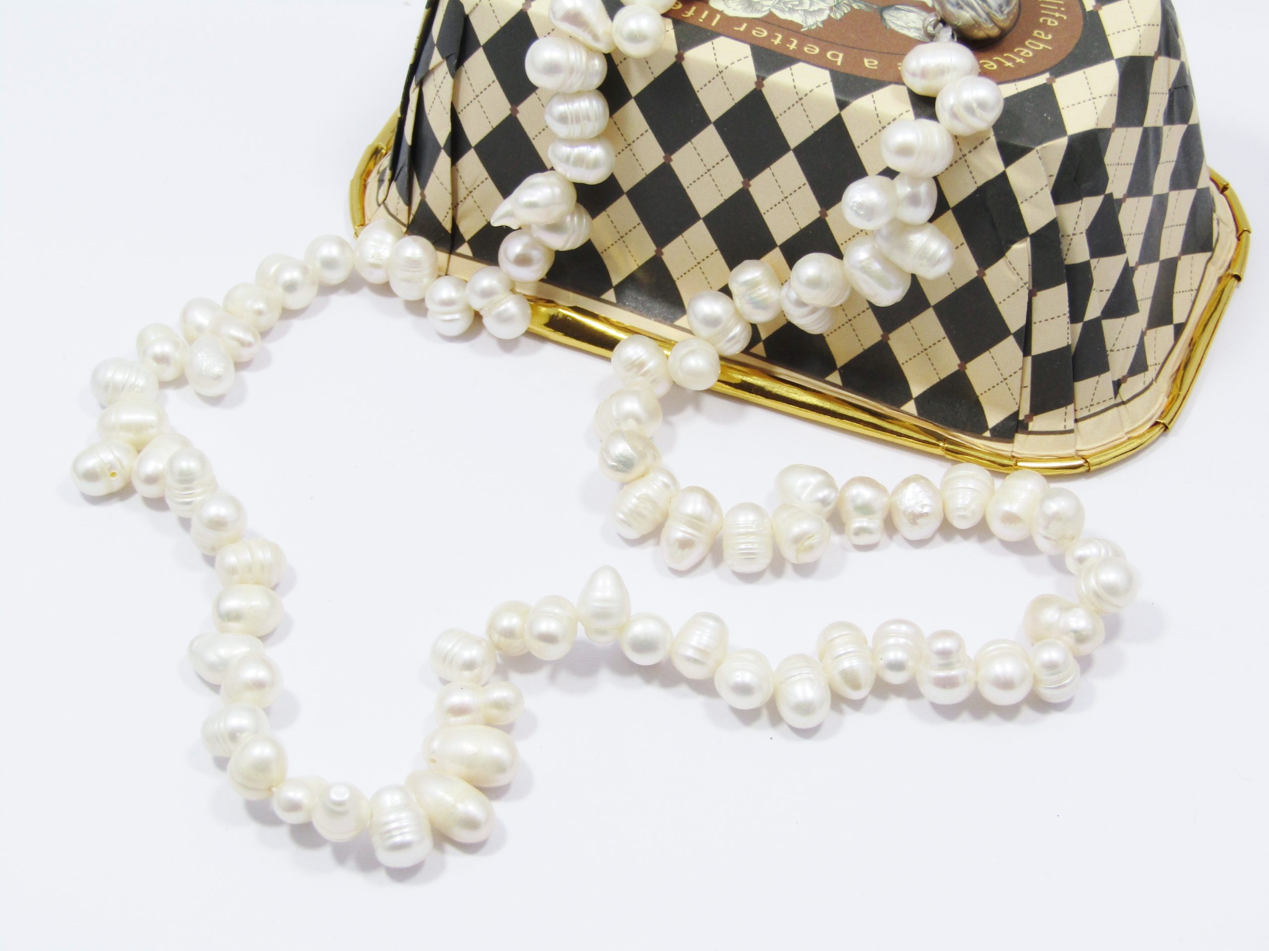 A Lovely String of Semi Baroque Fresh Water Pearls with a Silver Tone Magnet Clasp