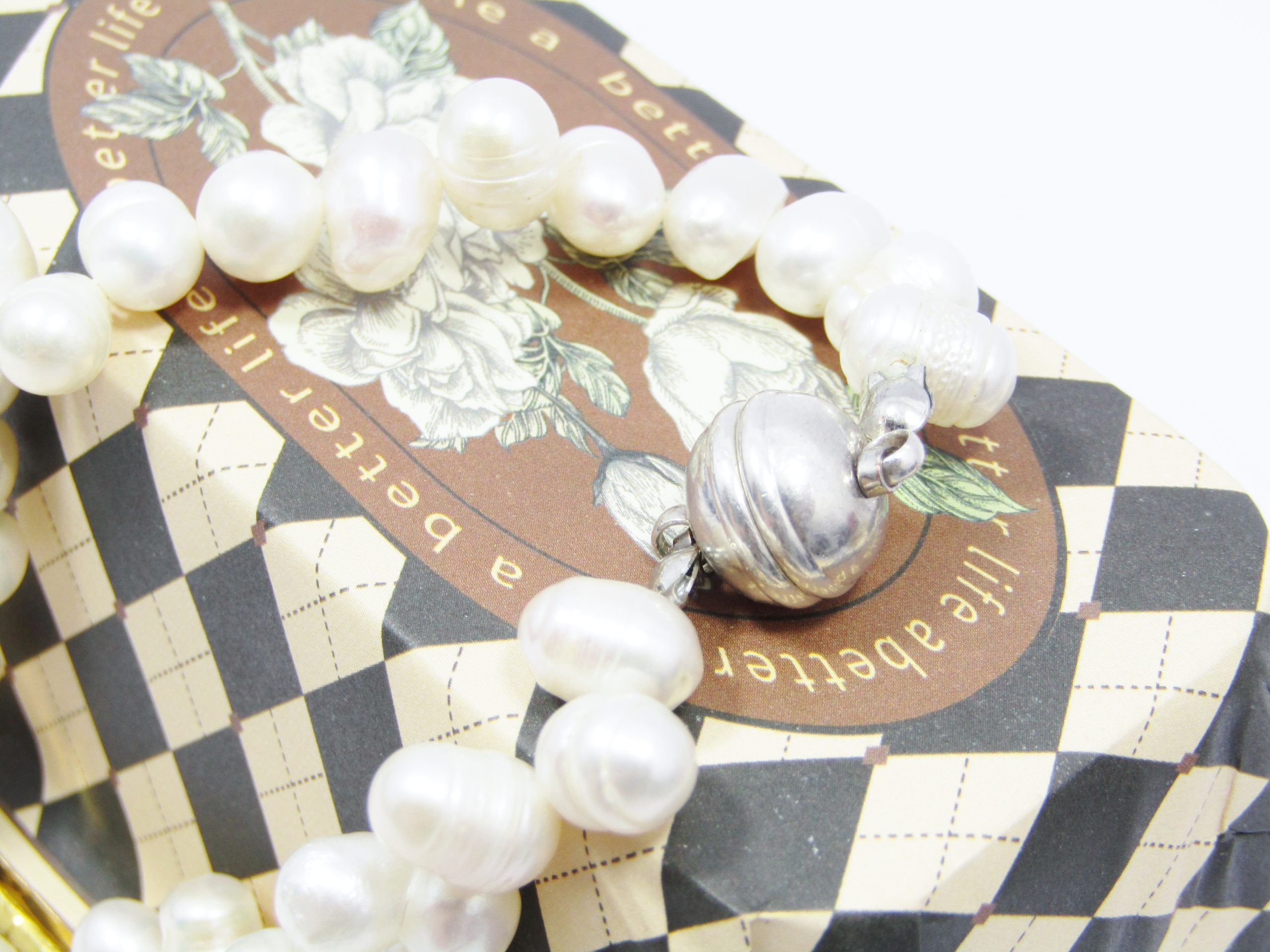 A Lovely String of Semi Baroque Fresh Water Pearls with a Silver Tone Magnet Clasp