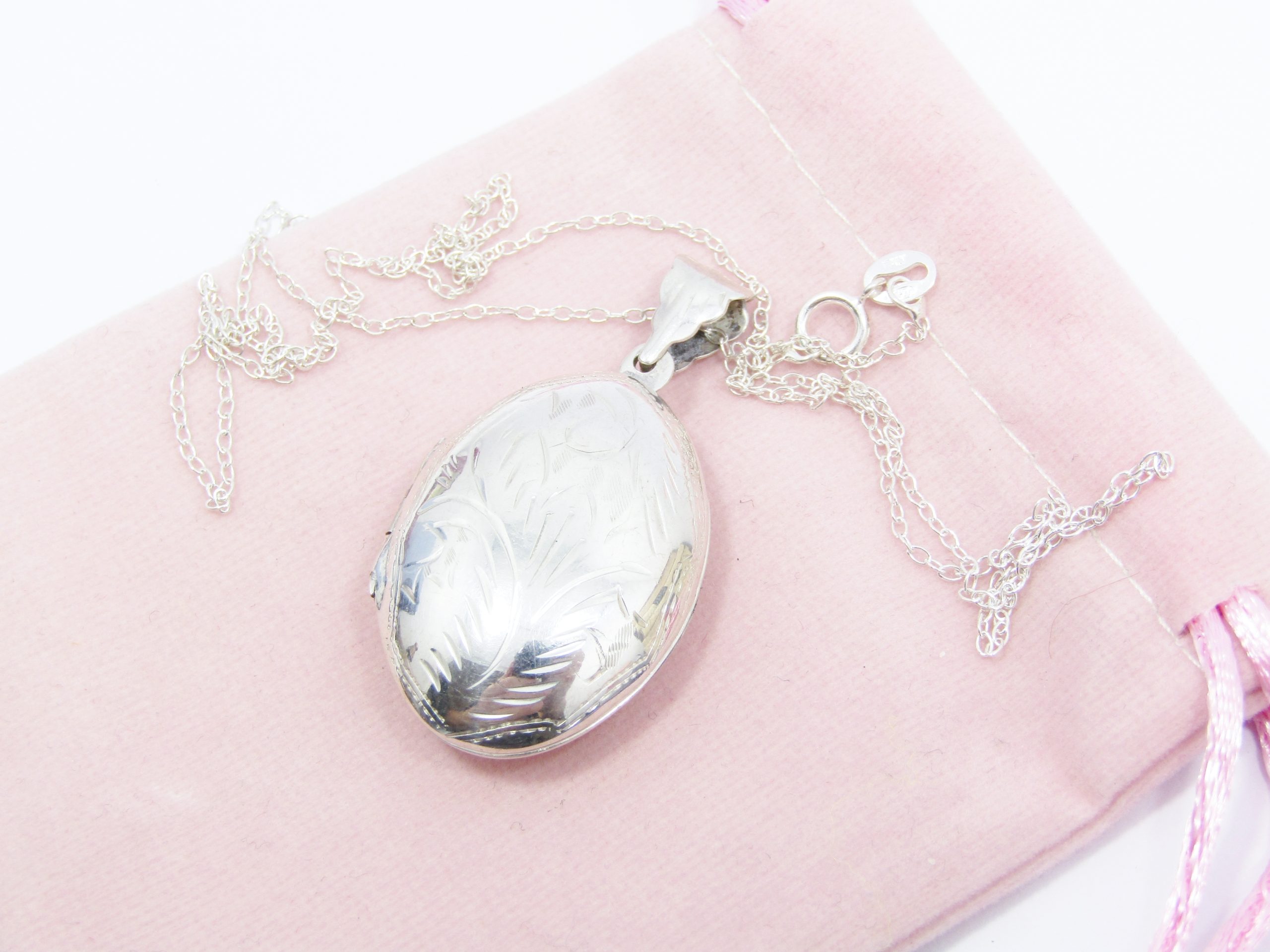 A Stunning Oval Engraved Locket On Chain in Sterling Silver