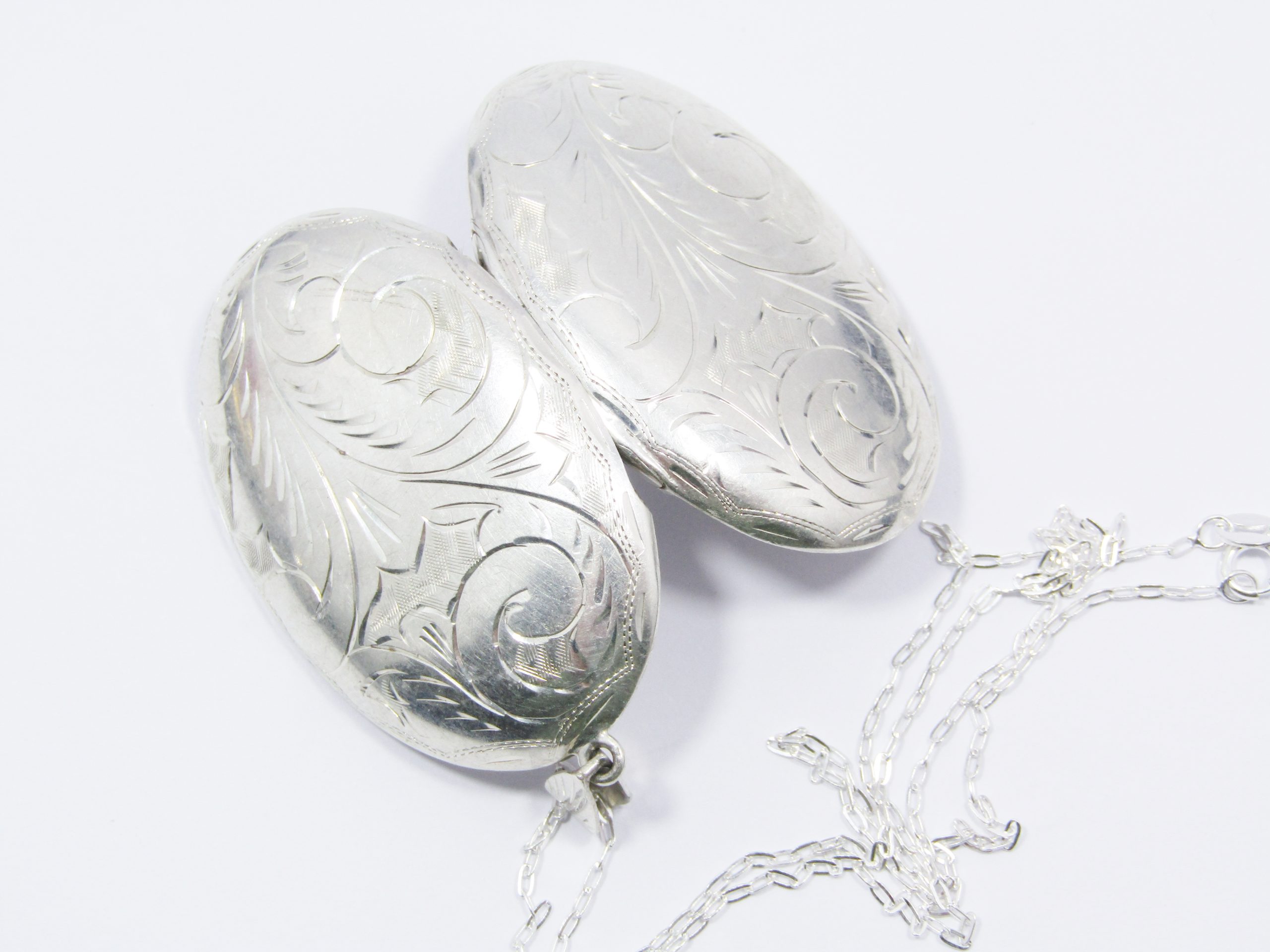 A Beautiful Vintage Design Large Oval Engraved Locket on Chain in Sterling Silver