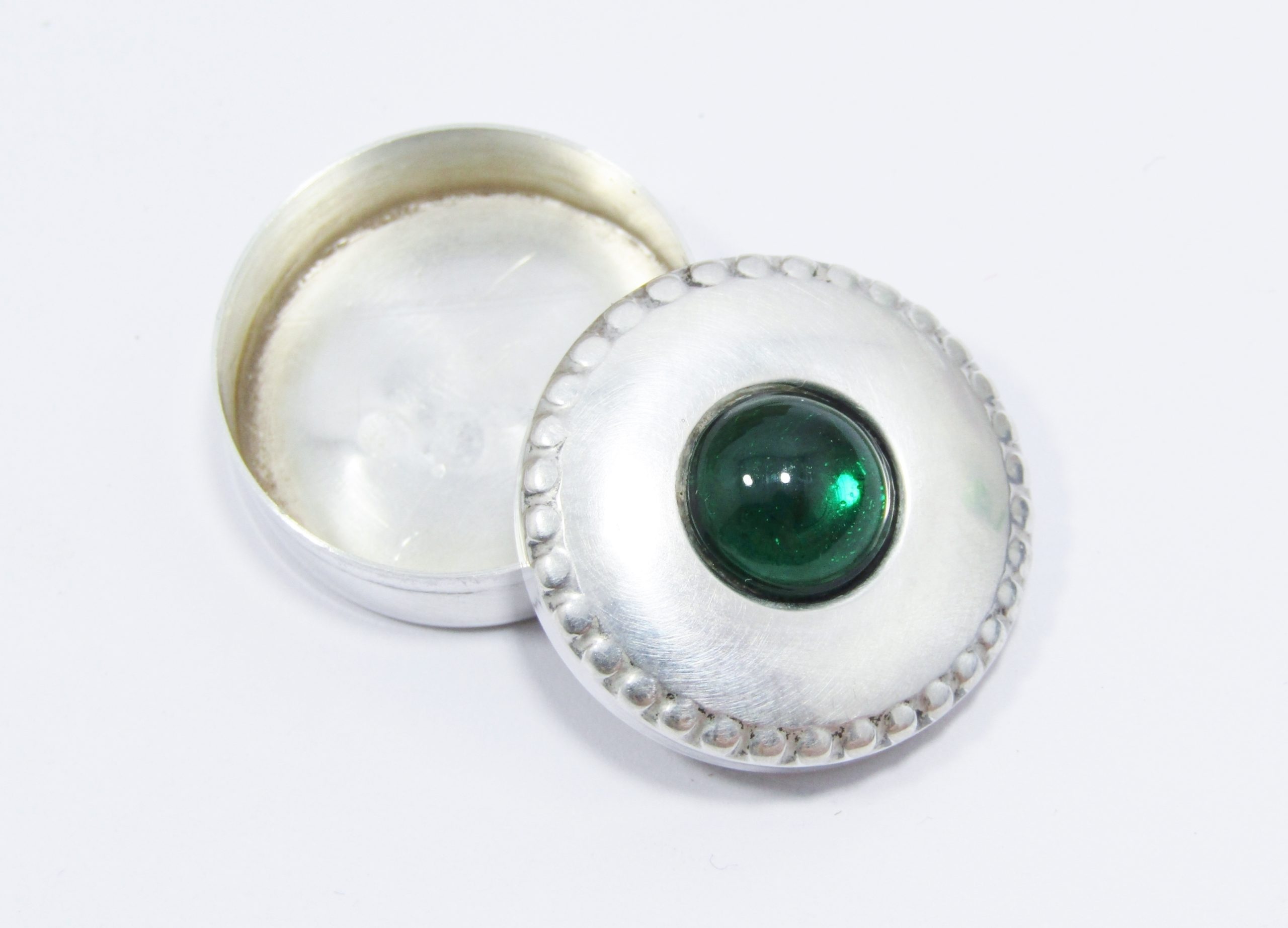 A Small Pill Box with a Green Center Stone With Spanish Hallmarks in Sterling Silver