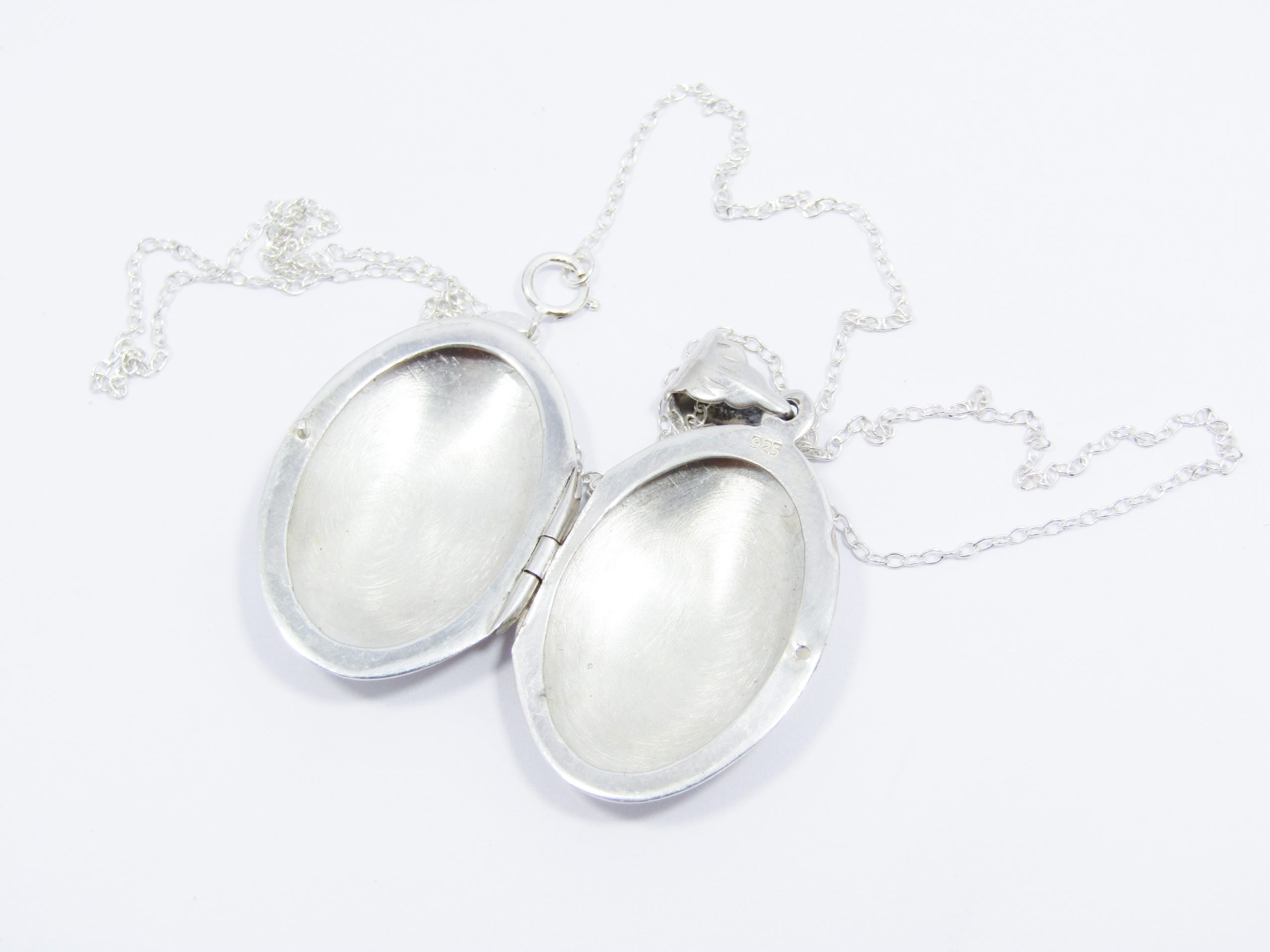 A Stunning Oval Engraved Locket On Chain in Sterling Silver