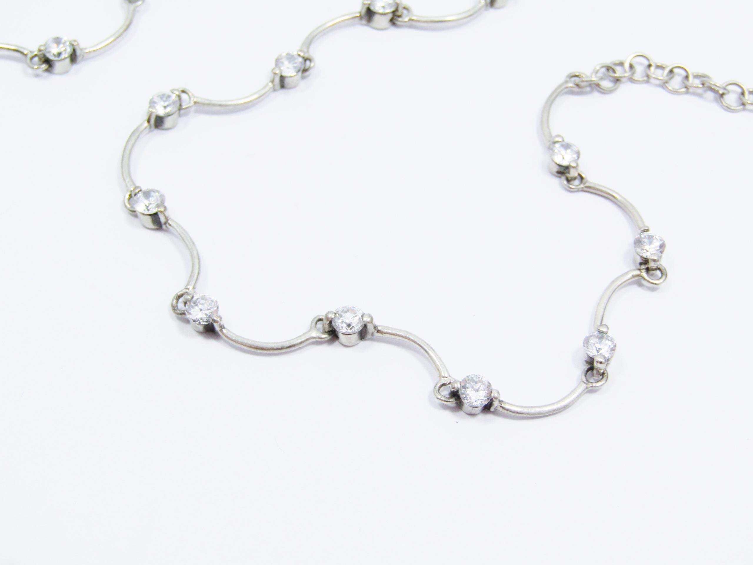 A Stunning Scallop Design Necklace Dotted with Clear Zirconia's in Sterling Silver.