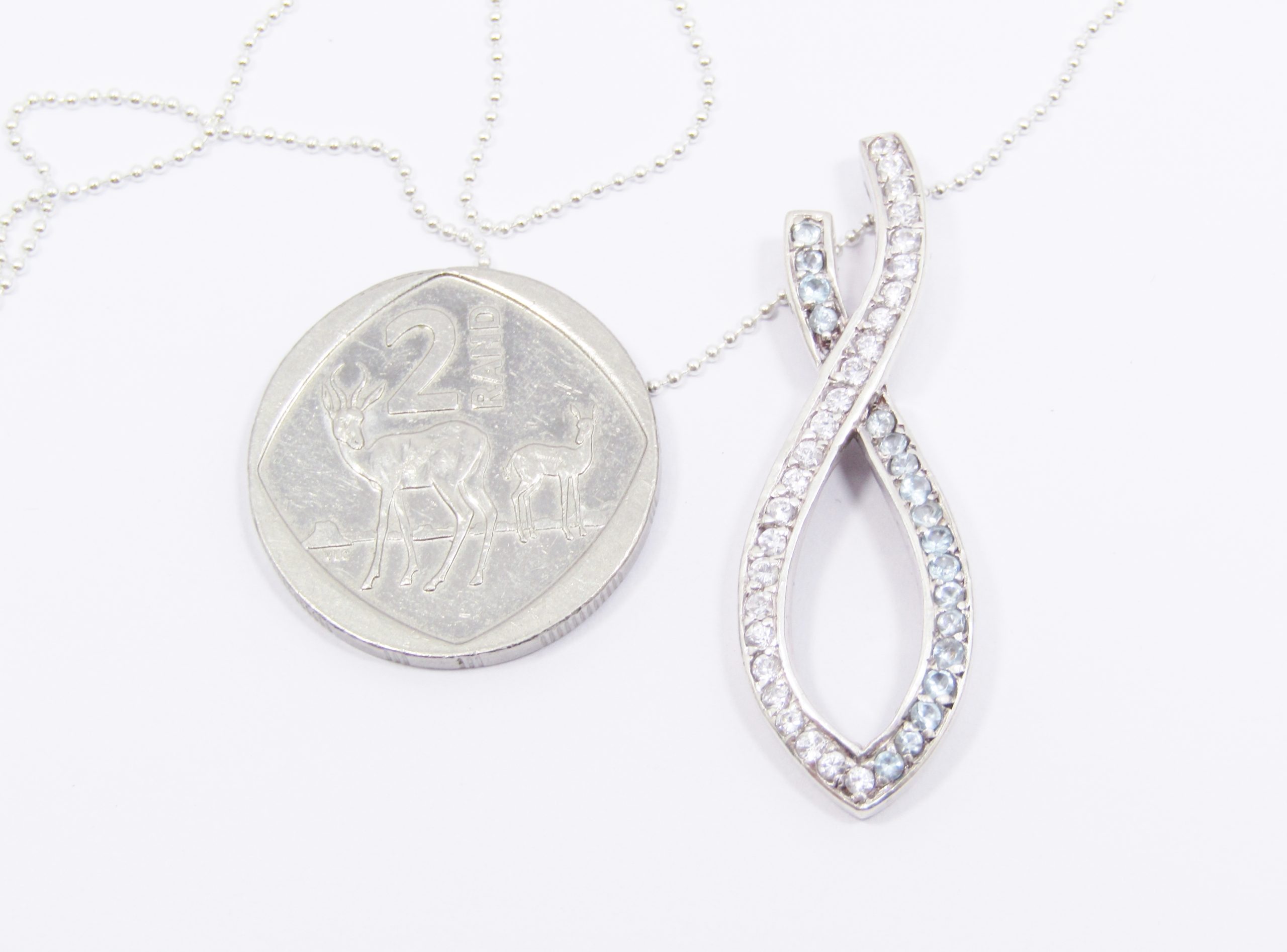 A Lovely Large Blue And White Zirconia Ribbon Pendant on Chain in Sterling Silver