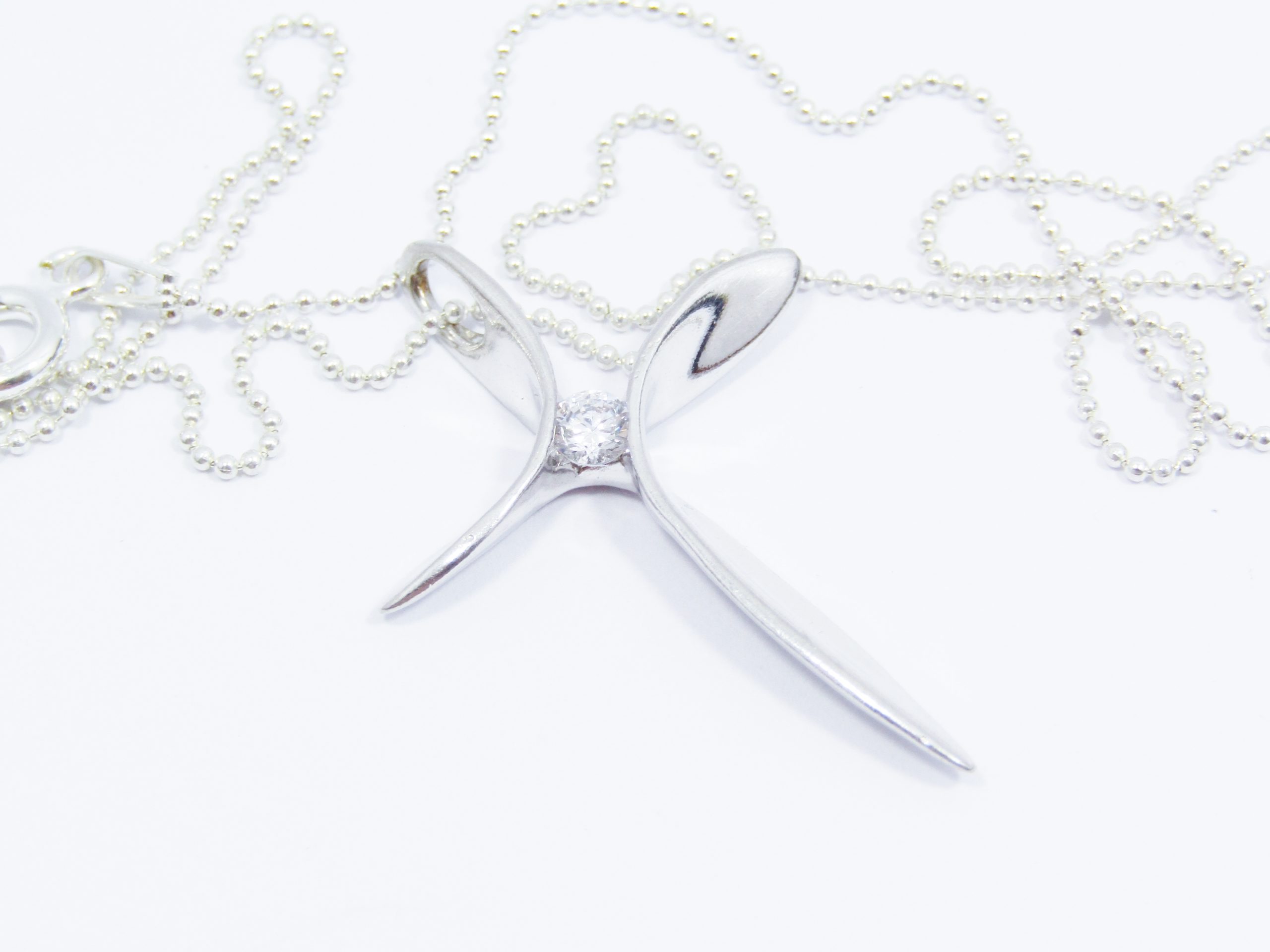 A Beautiful Abstract Design Cross with a Tiny Zirconia on Chain in Sterling Silver