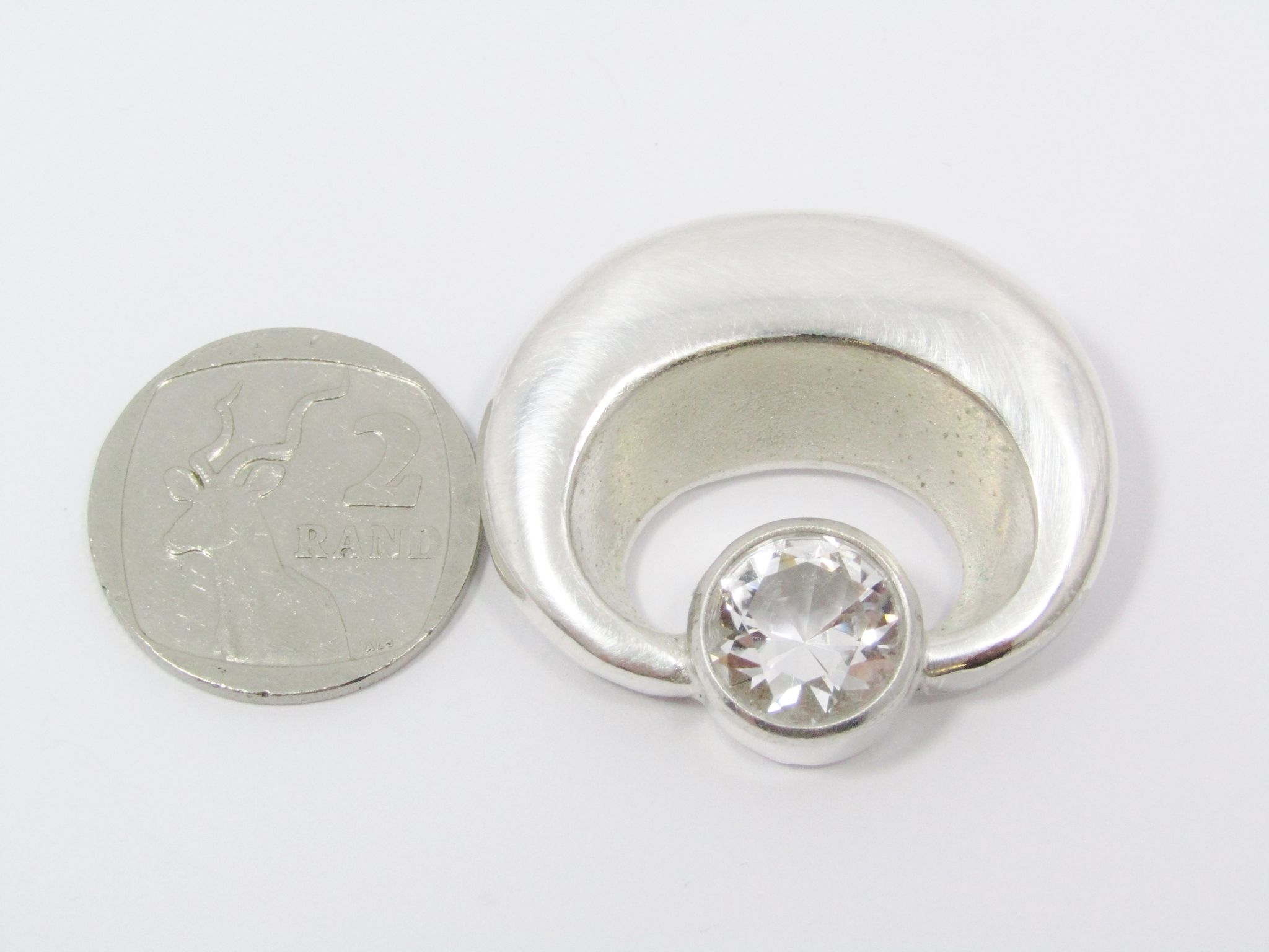 A Lovely Solid Modernist Style Brooch With a Rock Crystal in Silver.