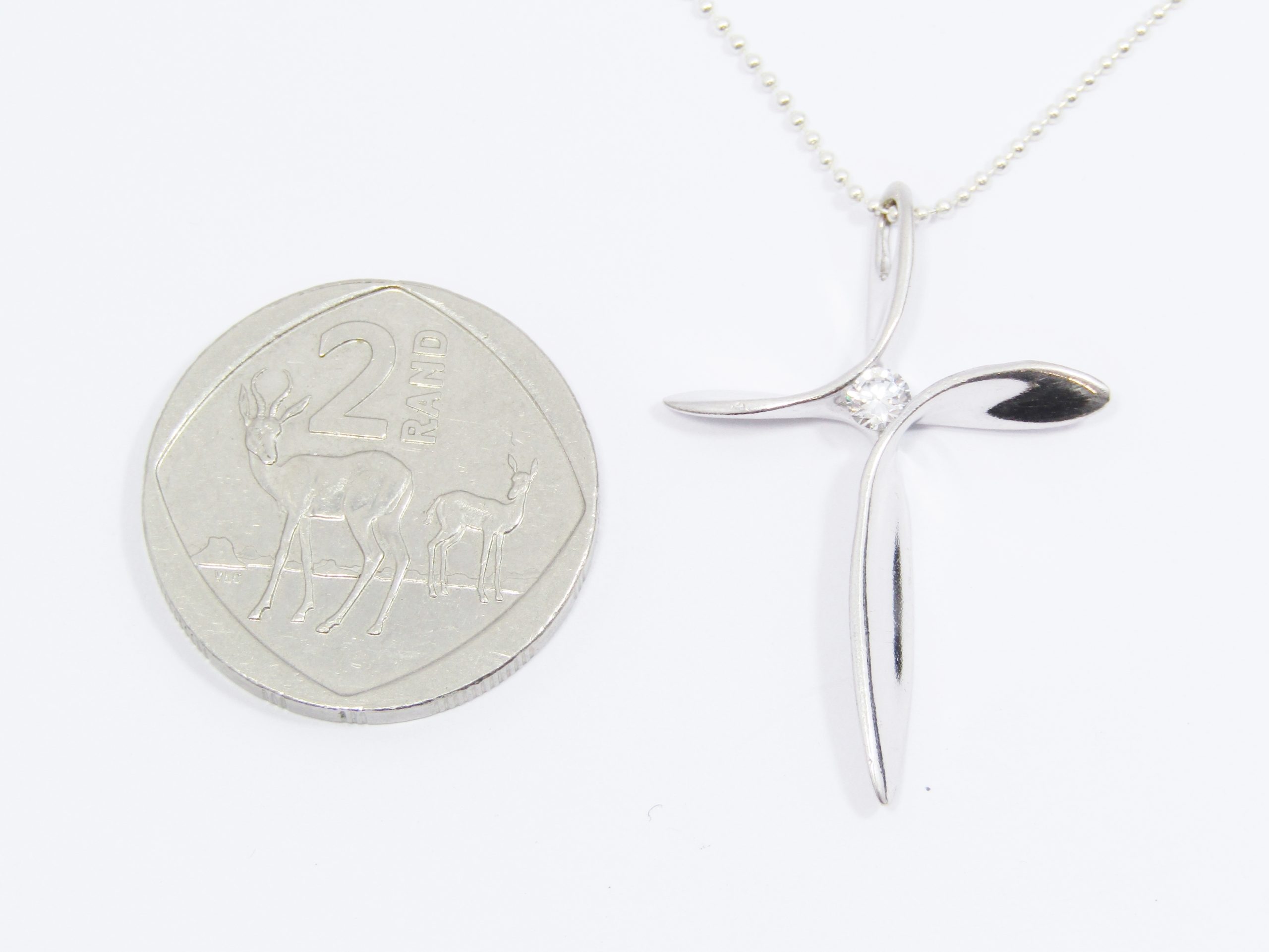 A Beautiful Abstract Design Cross with a Tiny Zirconia on Chain in Sterling Silver