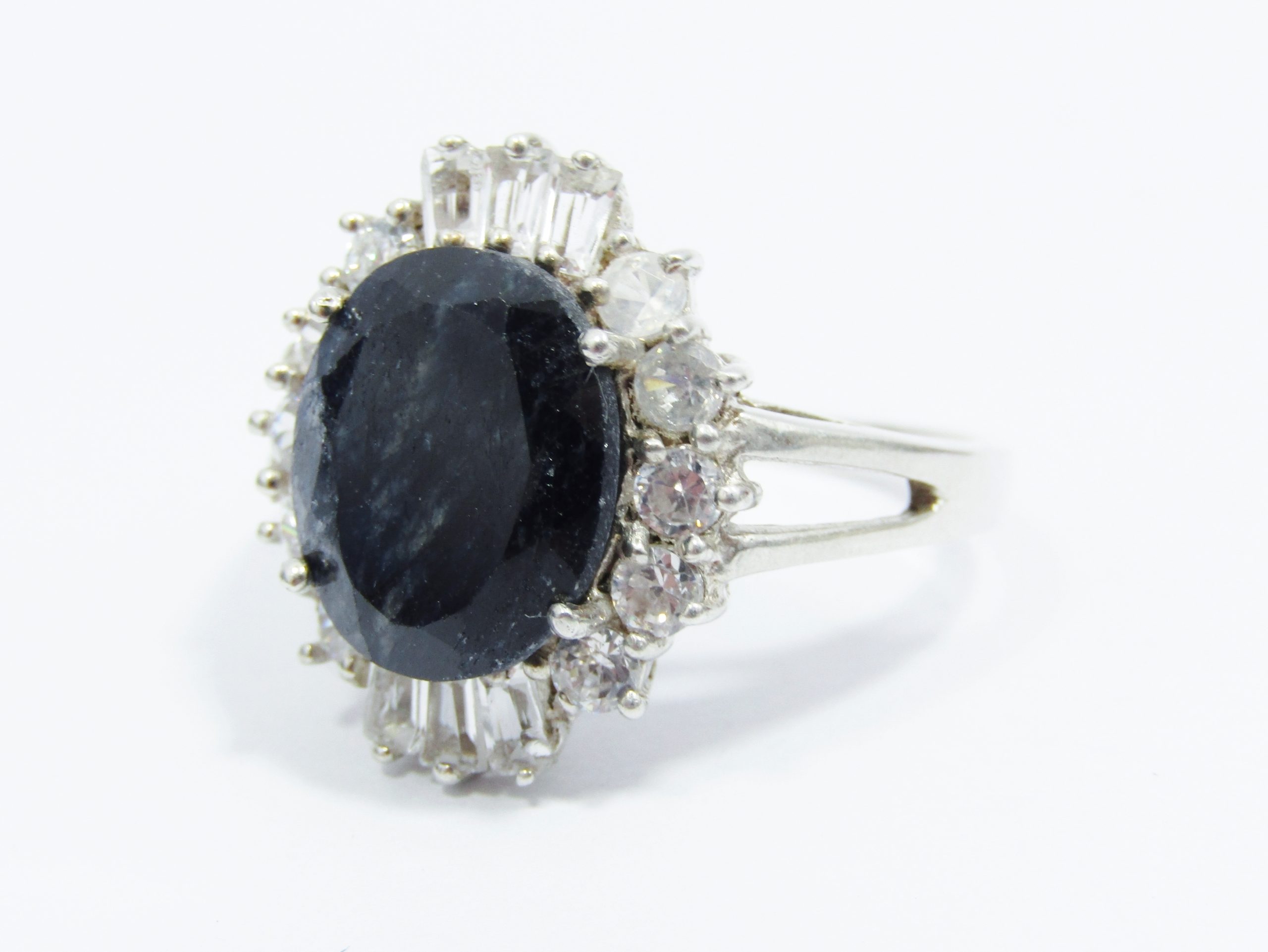A Gorgeous Dark Opaque Sapphire Ring Surrounded With Clear Baguette Zirconia's in Sterling Silv