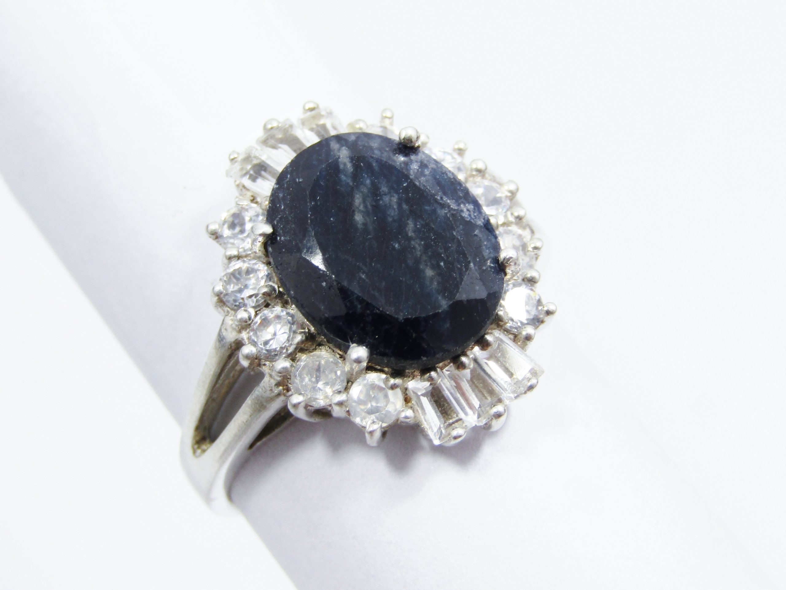 A Gorgeous Dark Opaque Sapphire Ring Surrounded With Clear Baguette Zirconia's in Sterling Silv