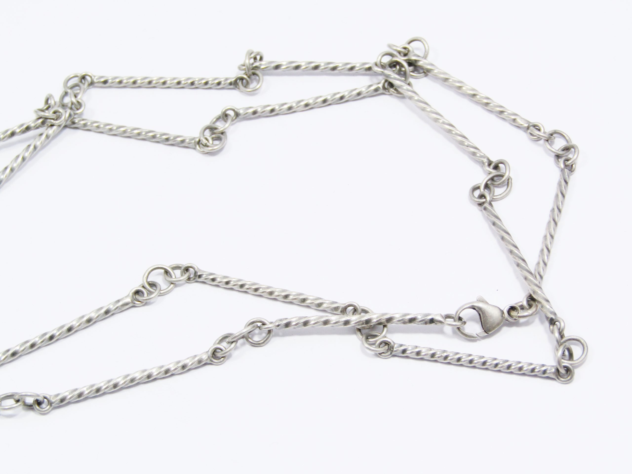 A Gorgeous Weighty Long Twisted Paneled Necklace in Sterling Silver.