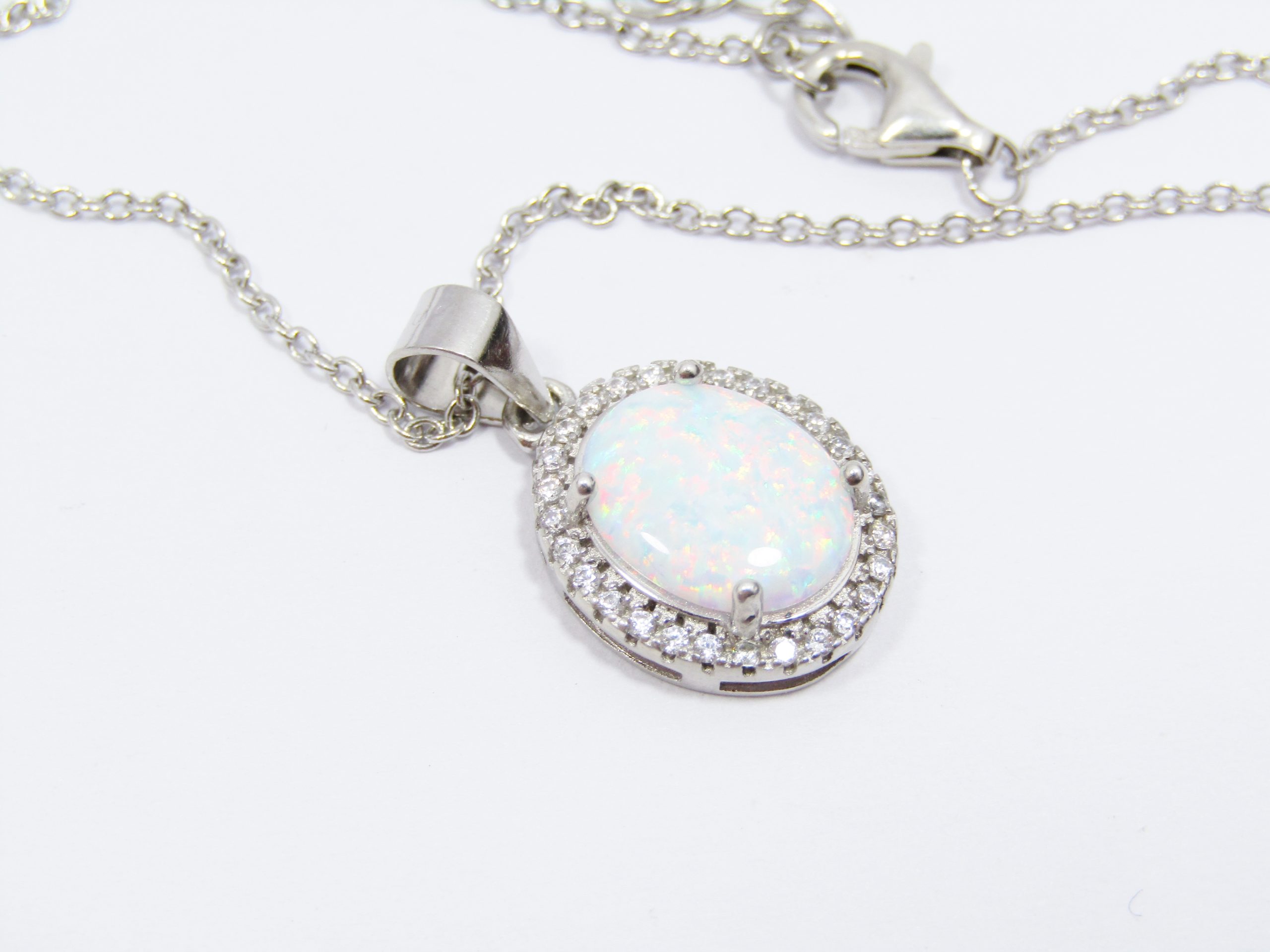 A Stunning Faux Opal Pendant Surrounded with Zirconia's on Chain in Sterling Silver.