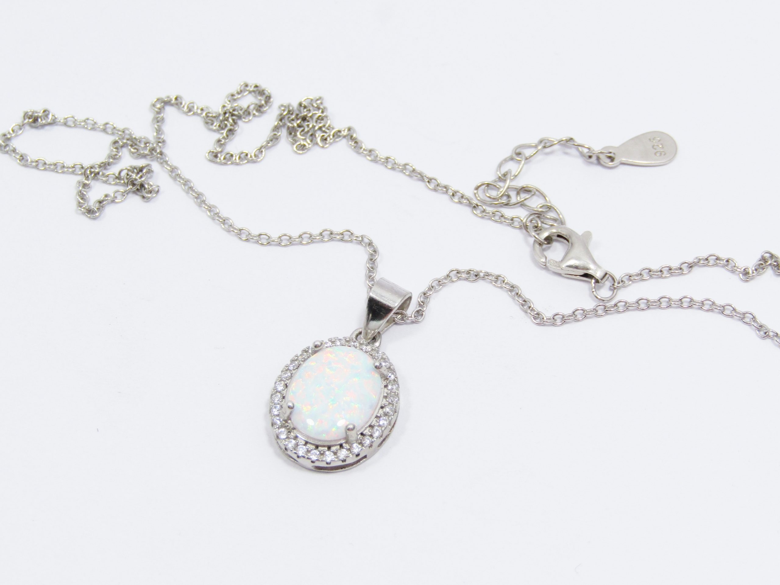 A Stunning Faux Opal Pendant Surrounded with Zirconia's on Chain in Sterling Silver.