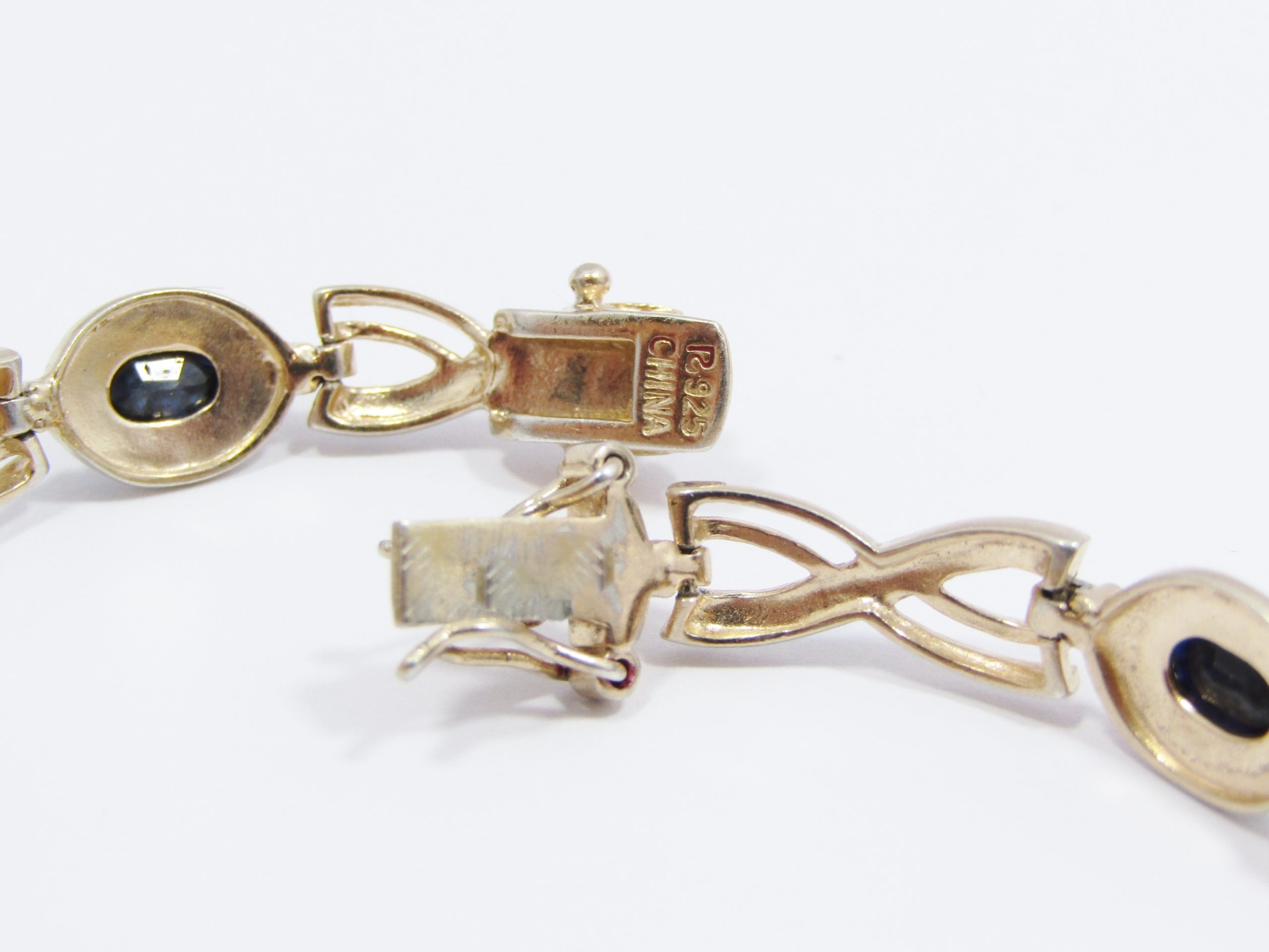 A Stunning Ornate Gold Plated Over Sterling Silver Opaque Sapphires and Clear Zirconia Tennis Bracelet
