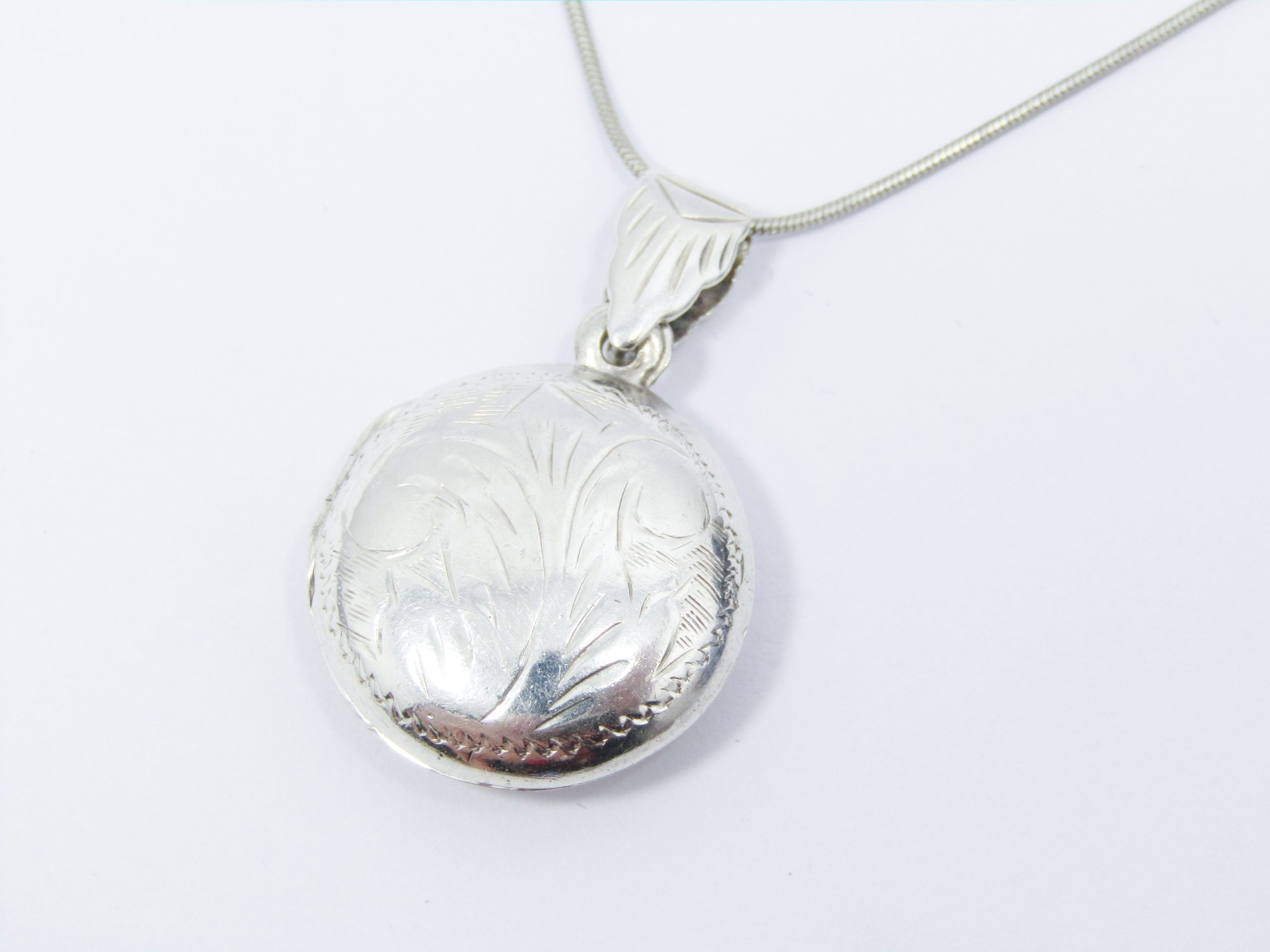 A Lovely Vintage Design Round Engraved Reversable Locket On Chain in Sterling Silver.