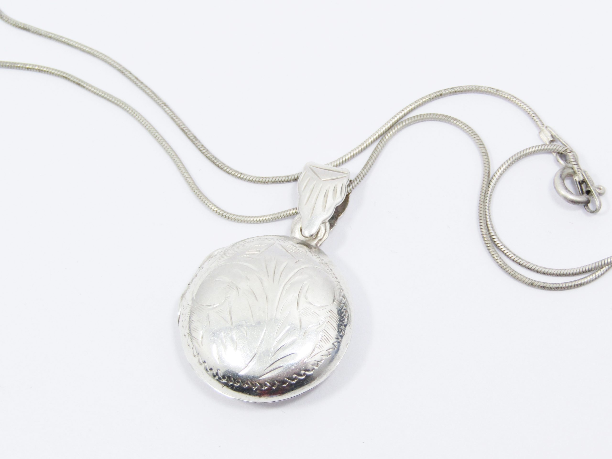 A Lovely Vintage Design Round Engraved Reversable Locket On Chain in Sterling Silver.