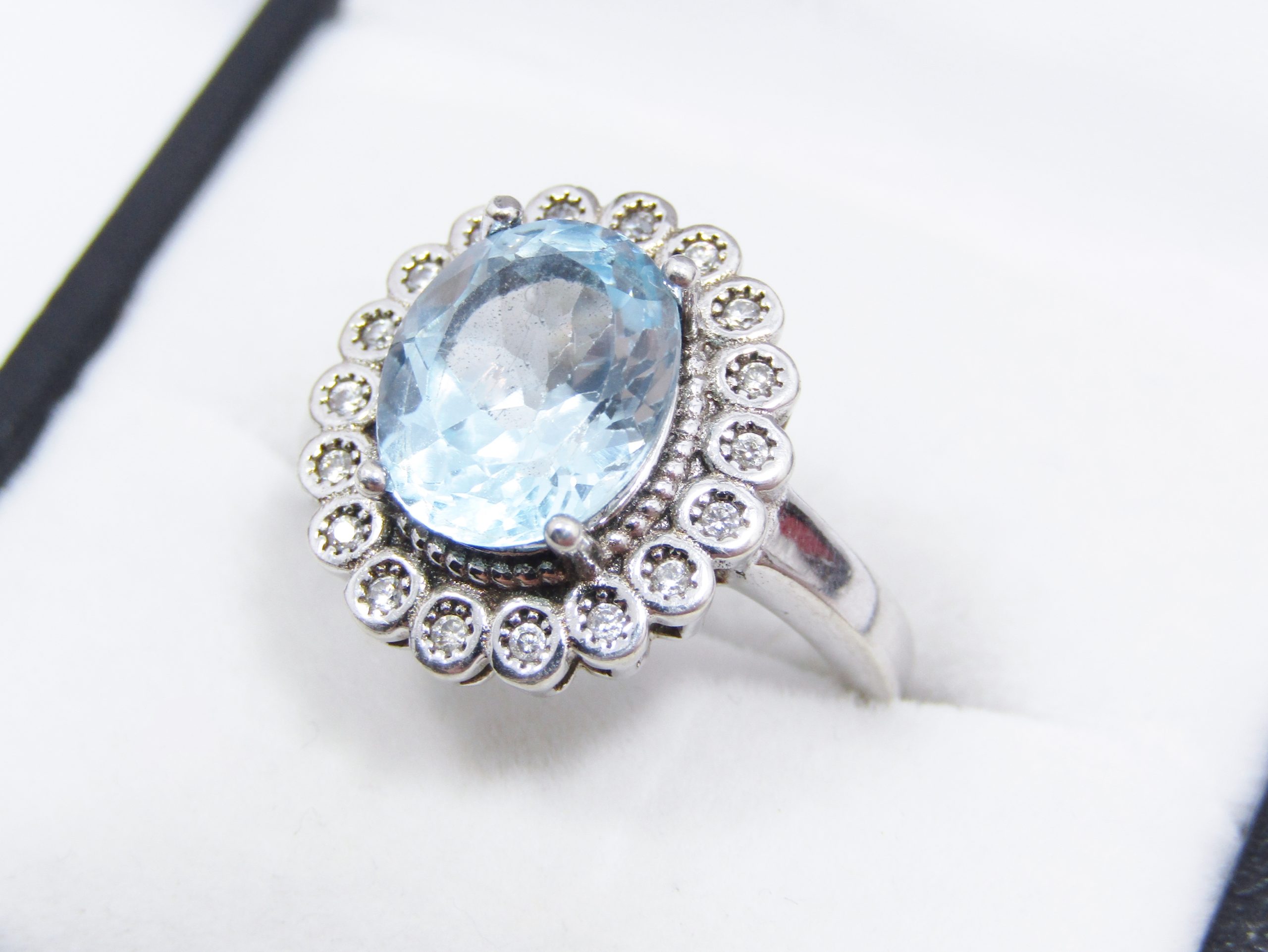 A Stunning Halo Design Blue Topaz Ring Surrounded with Zirconia's in Sterling Silver