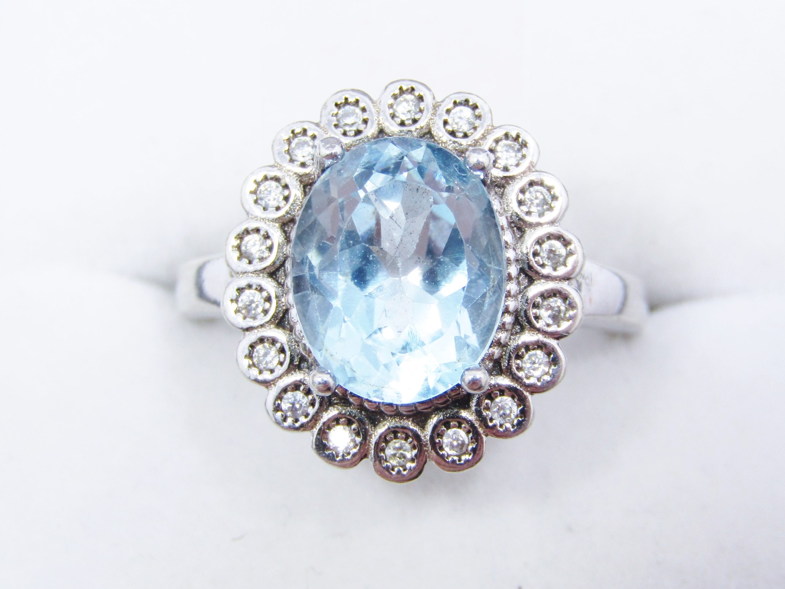 A Stunning Halo Design Blue Topaz Ring Surrounded with Zirconia's in Sterling Silver