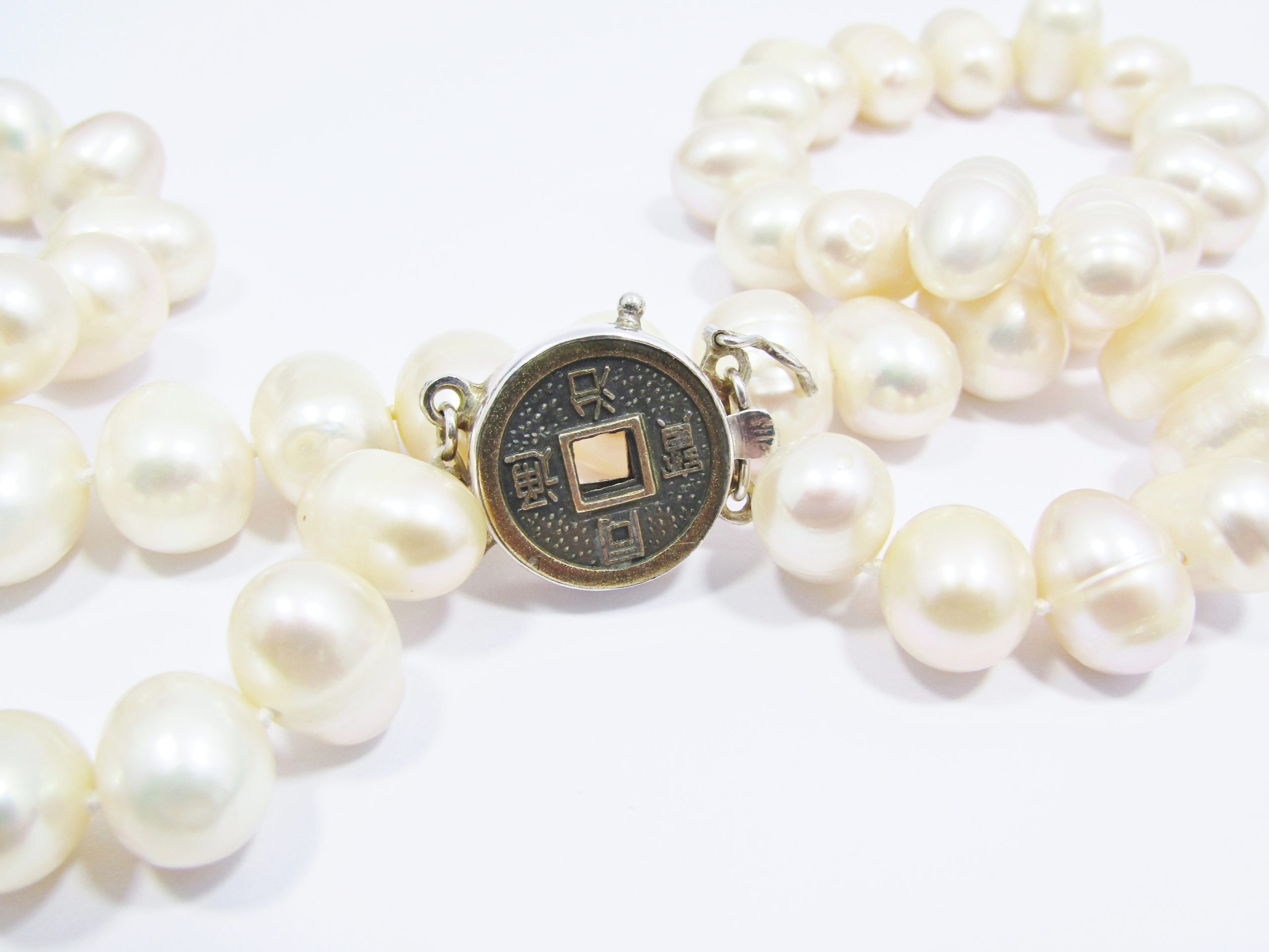 A Gorgeous String of Fresh Water Pearls with a good luck Coin Clasp in Sterling Silver