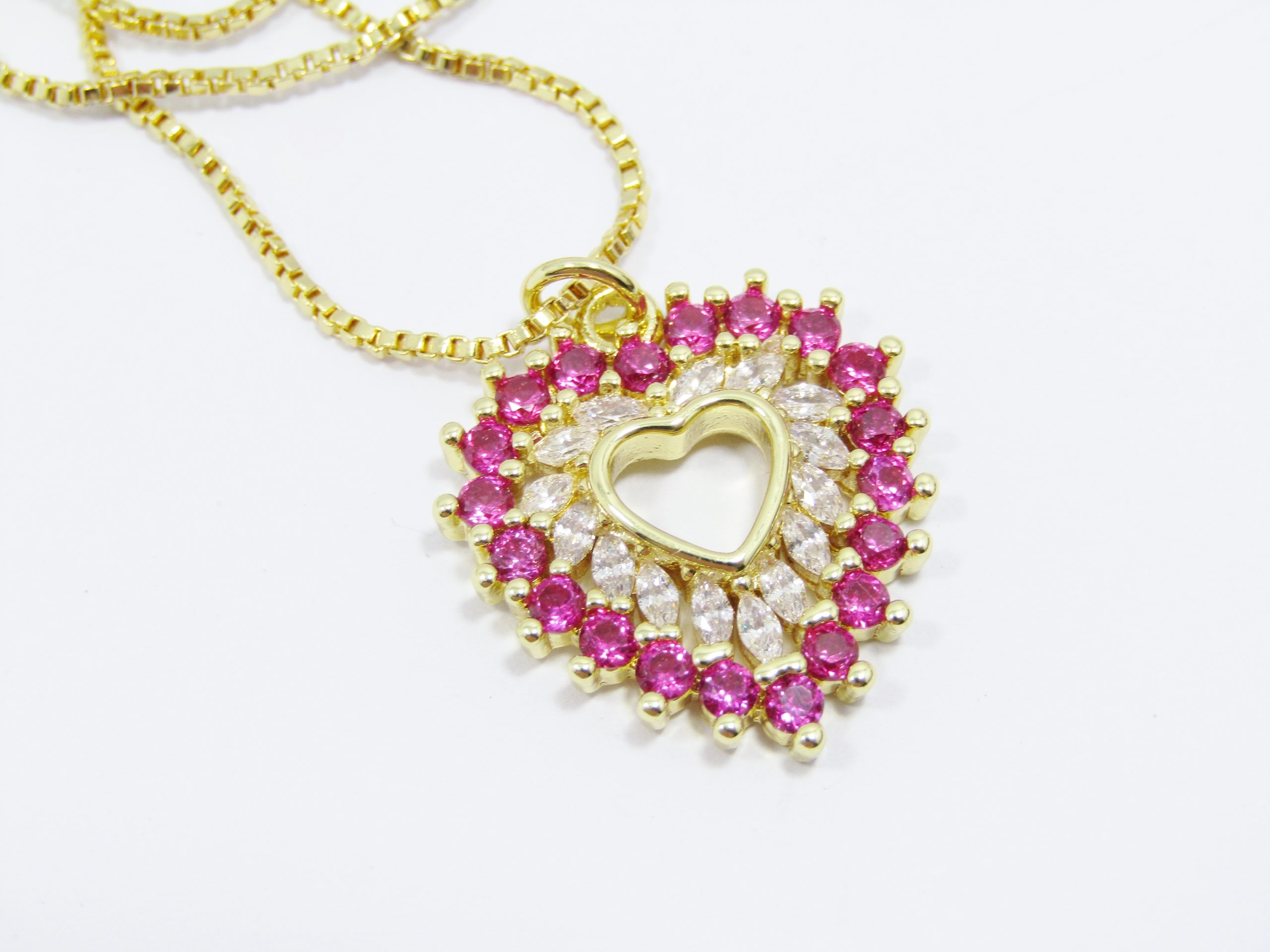 A Beautiful Gold Plated Vivid Pink Zirconia Heart Pendant on Chain in Sterling Silver.