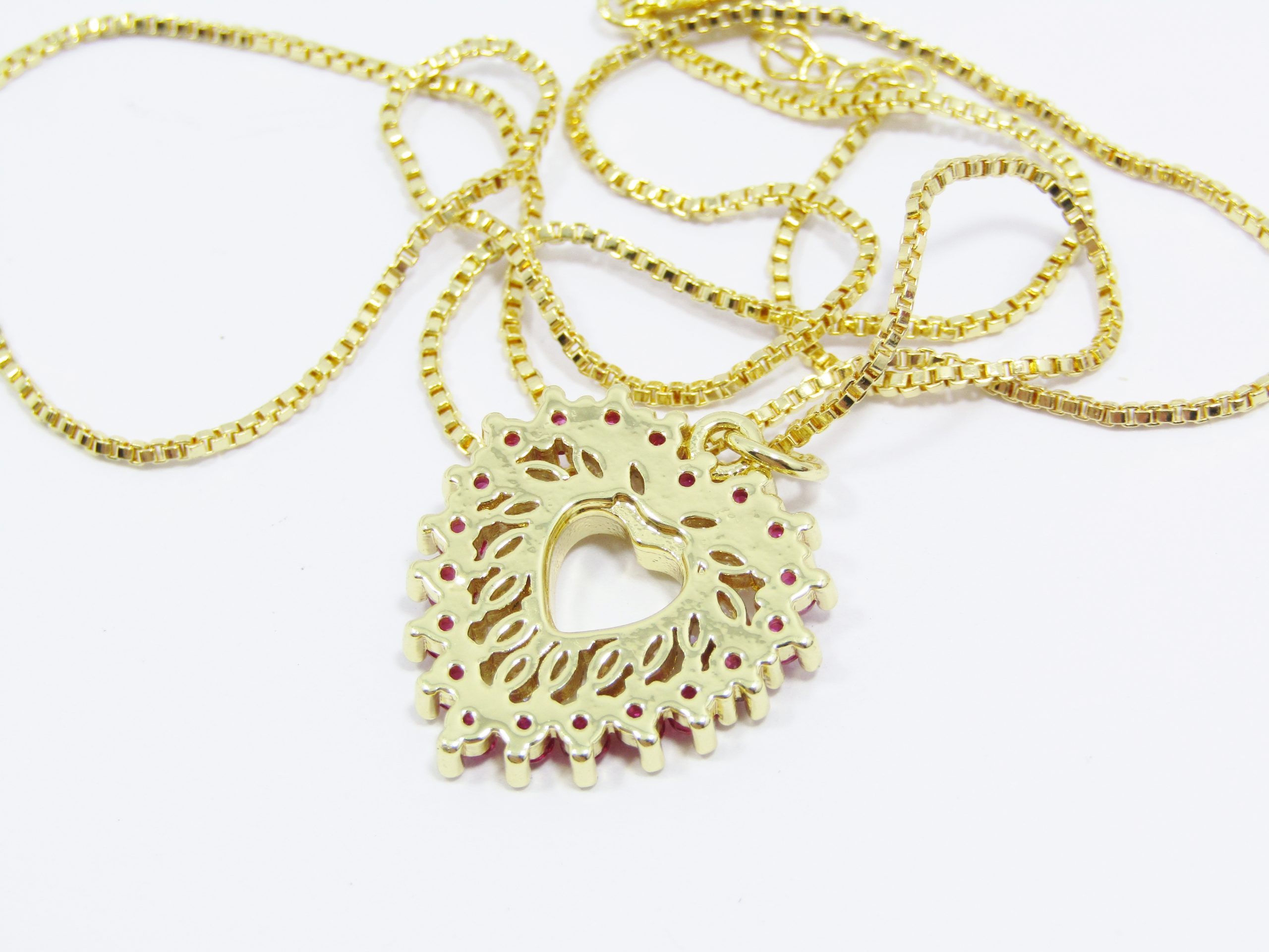 A Beautiful Gold Plated Vivid Pink Zirconia Heart Pendant on Chain in Sterling Silver.